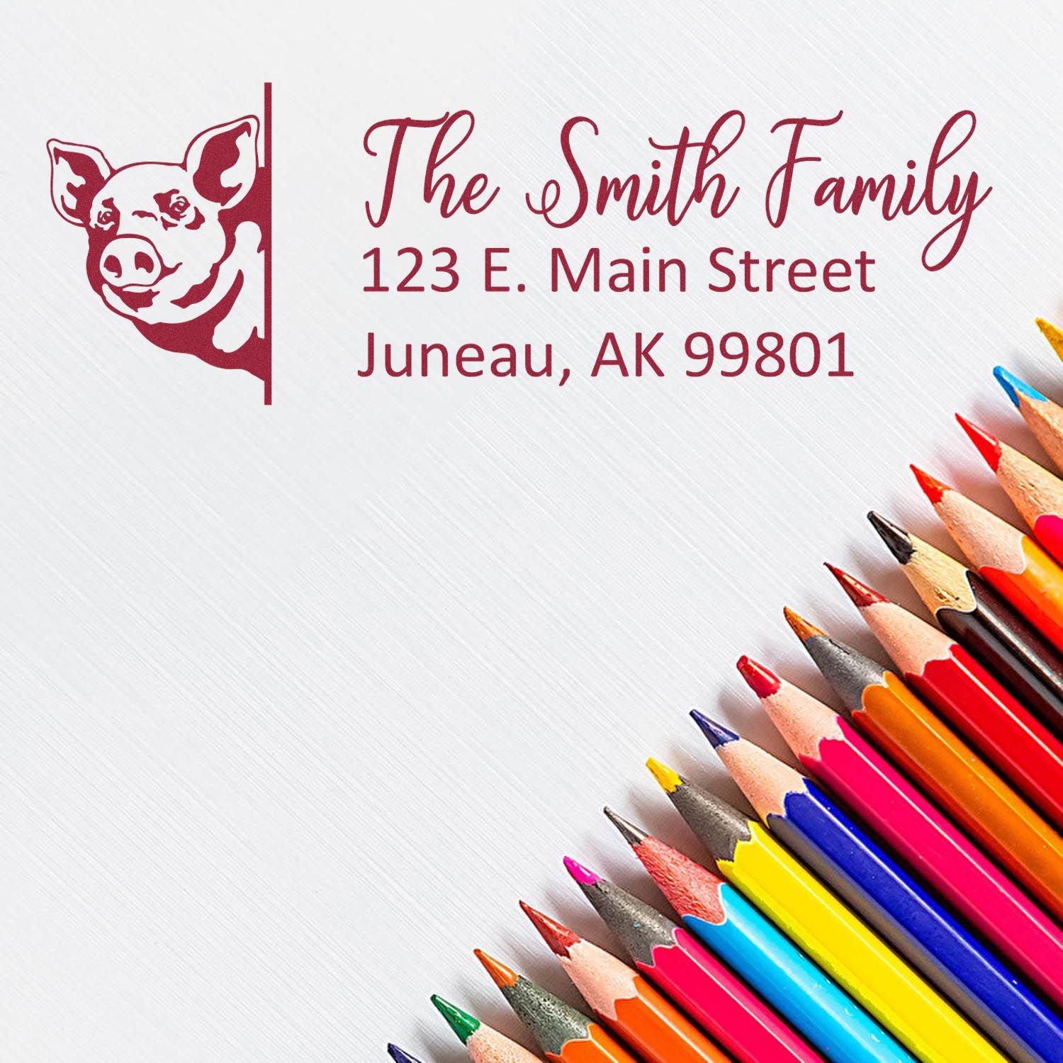 Custom family address rubber stamp with pig logo for personalized mailing and stationery.