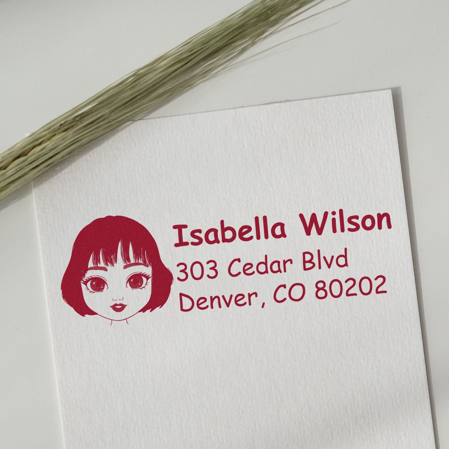 Custom rubber address stamp with girl illustration for mailing envelopes, personalized with name and Denver, CO address.