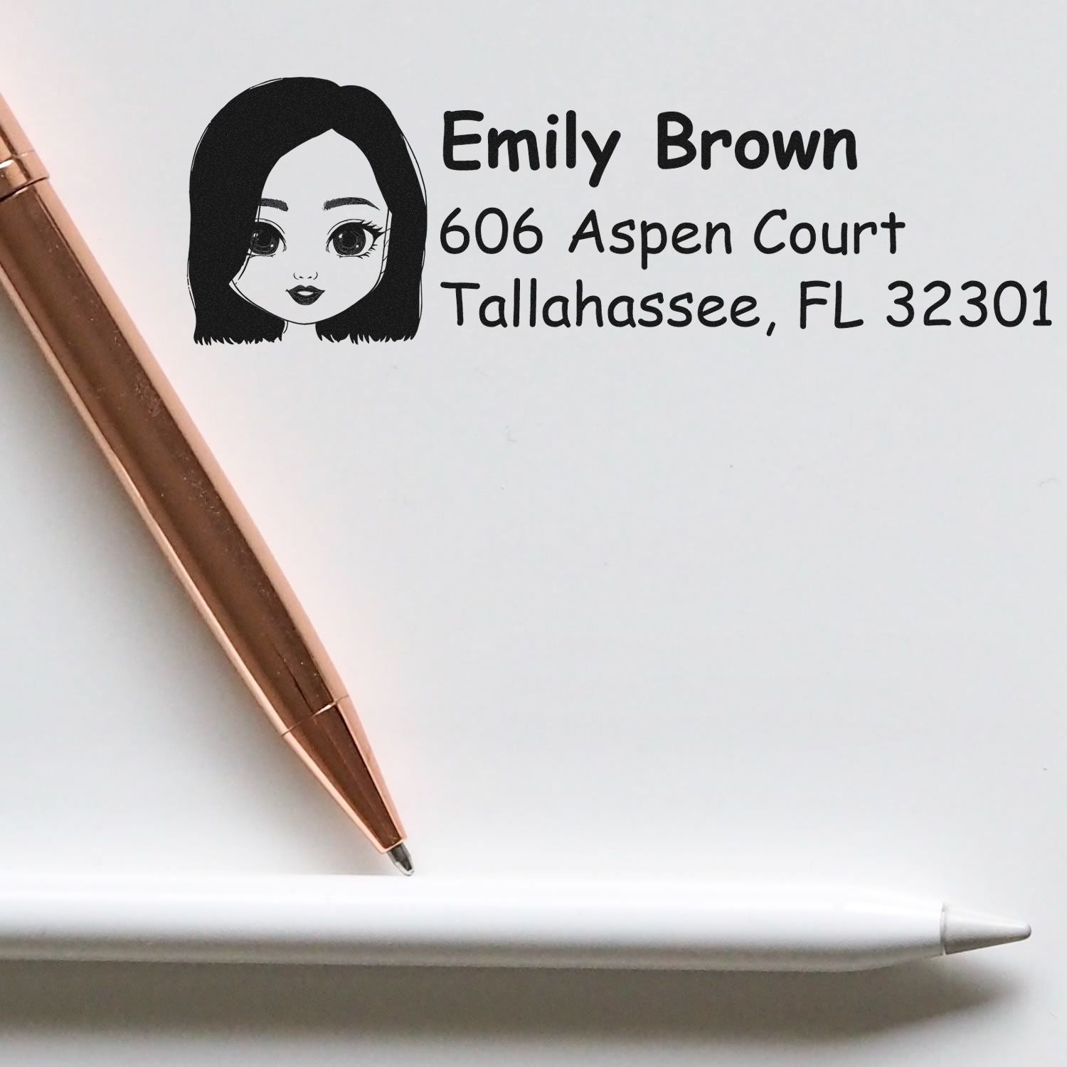 Custom return address rubber stamp with cartoon girl design for Emily Brown, 606 Aspen Court, Tallahassee, FL 32301.
