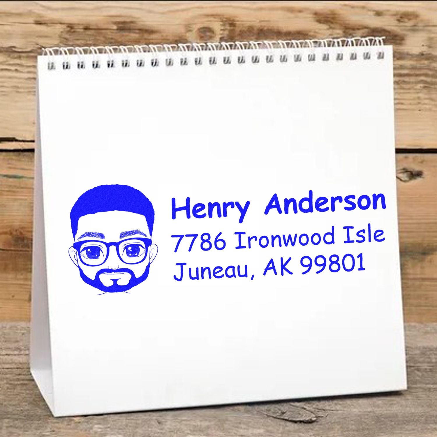 Custom address rubber stamp with avatar logo, name, and Juneau, AK address on a white paper bag.