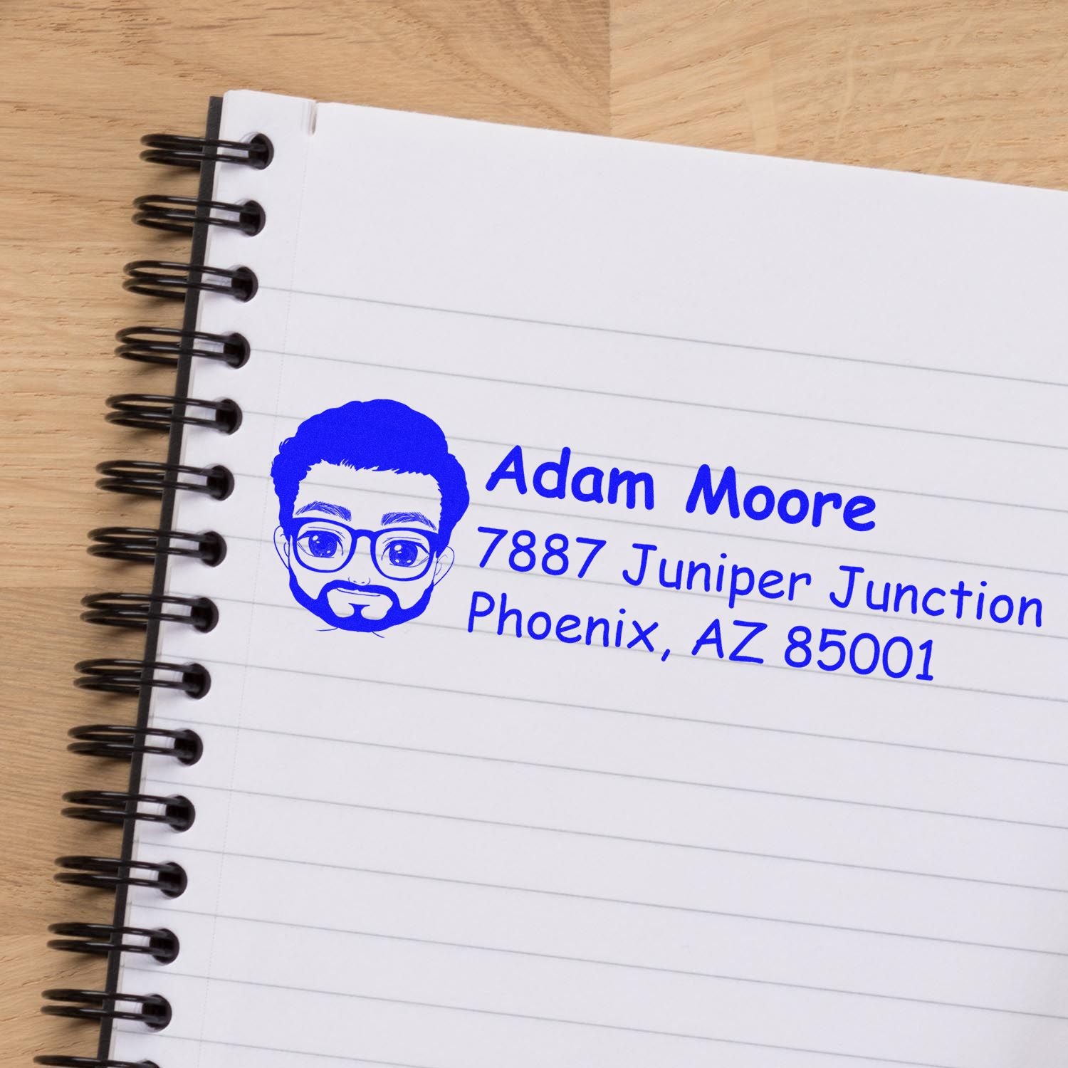 Custom rubber address stamp with avatar logo for Adam Moore, showing name and Phoenix, AZ mailing address.