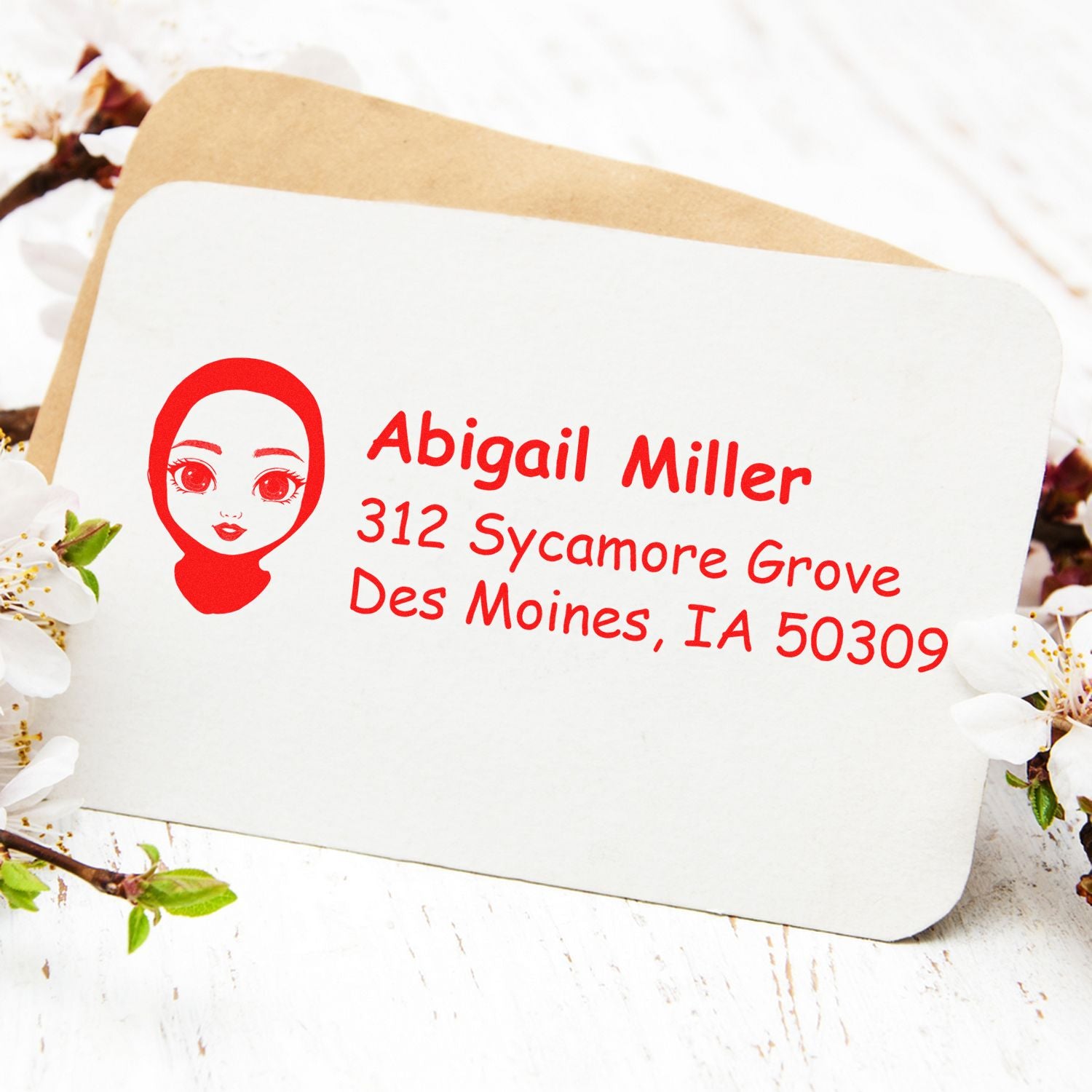 Personalized address rubber stamp for Abigail Miller, 312 Sycamore Grove, Des Moines, IA 50309, shown on envelope.