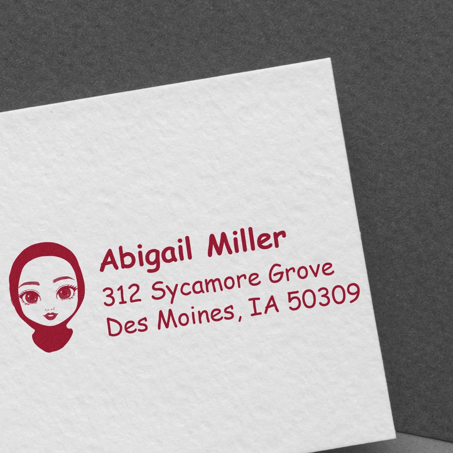 Custom address rubber stamp with name, avatar logo, and return address for mailing and stationery.