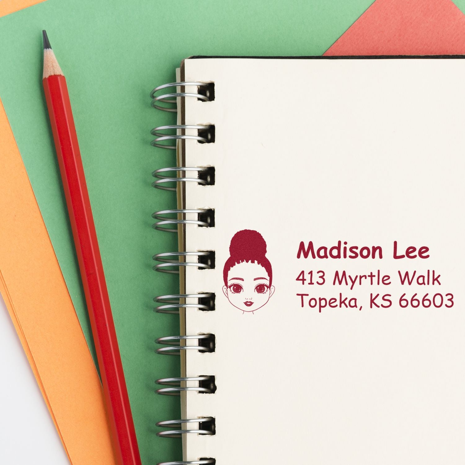 Custom address rubber stamp on notebook page, featuring name and address for personalized stationery and mailing labels.