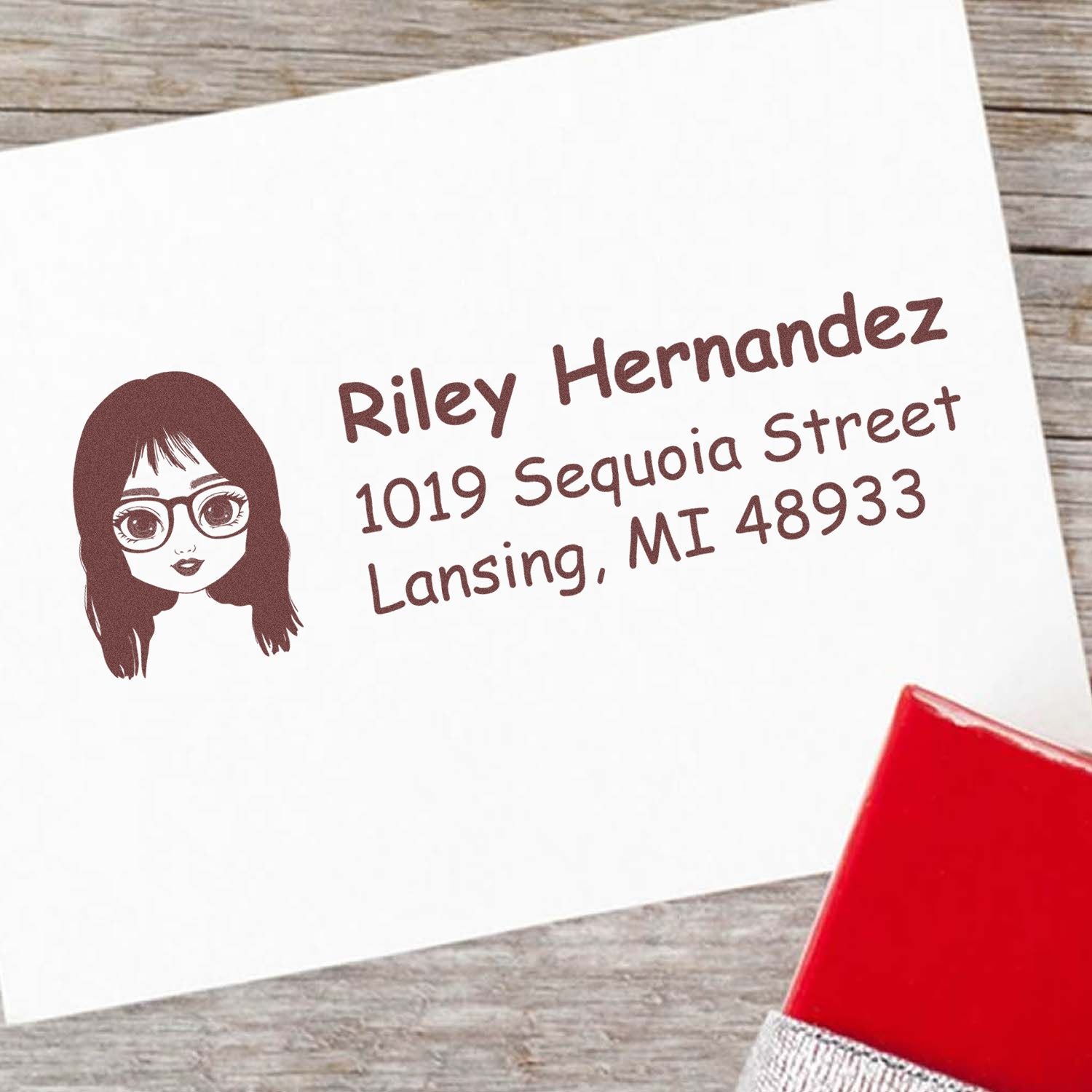 Personalized address rubber stamp with avatar, featuring Riley Hernandez and Lansing, MI return address on envelope.