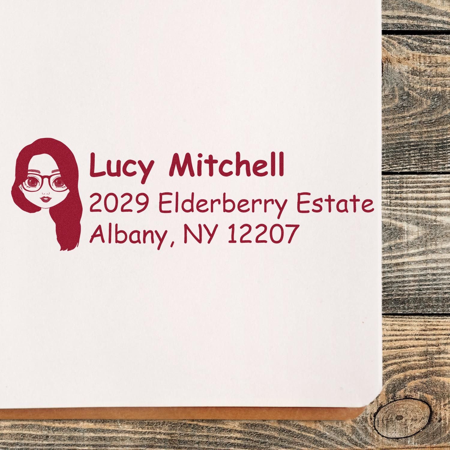 Custom return address rubber stamp with name and address for personalized envelopes: Lucy Mitchell, Albany, NY 12207.