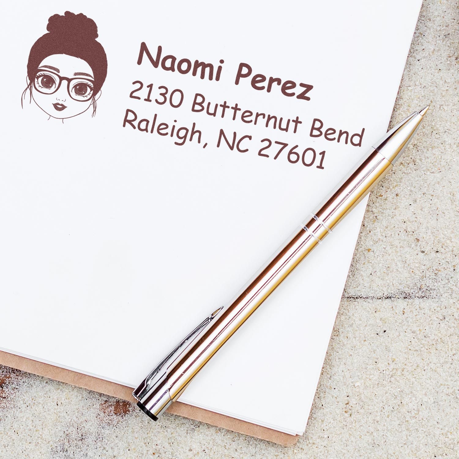 Custom return address rubber stamp for Naomi Perez, Raleigh NC, with girl logo for personal stationery and envelopes.