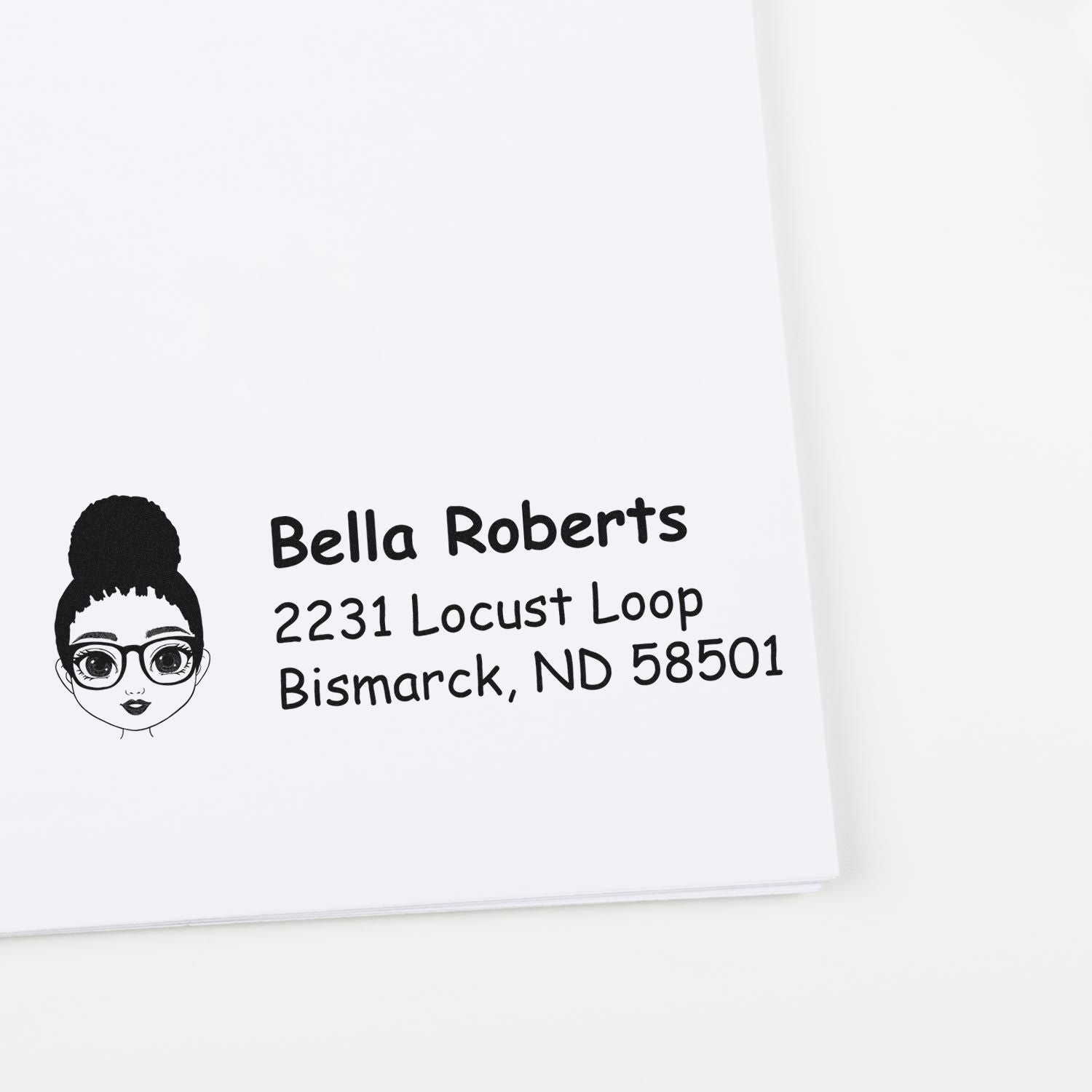 Custom return address rubber stamp with cartoon girl avatar and Bella Roberts address in Bismarck, ND.