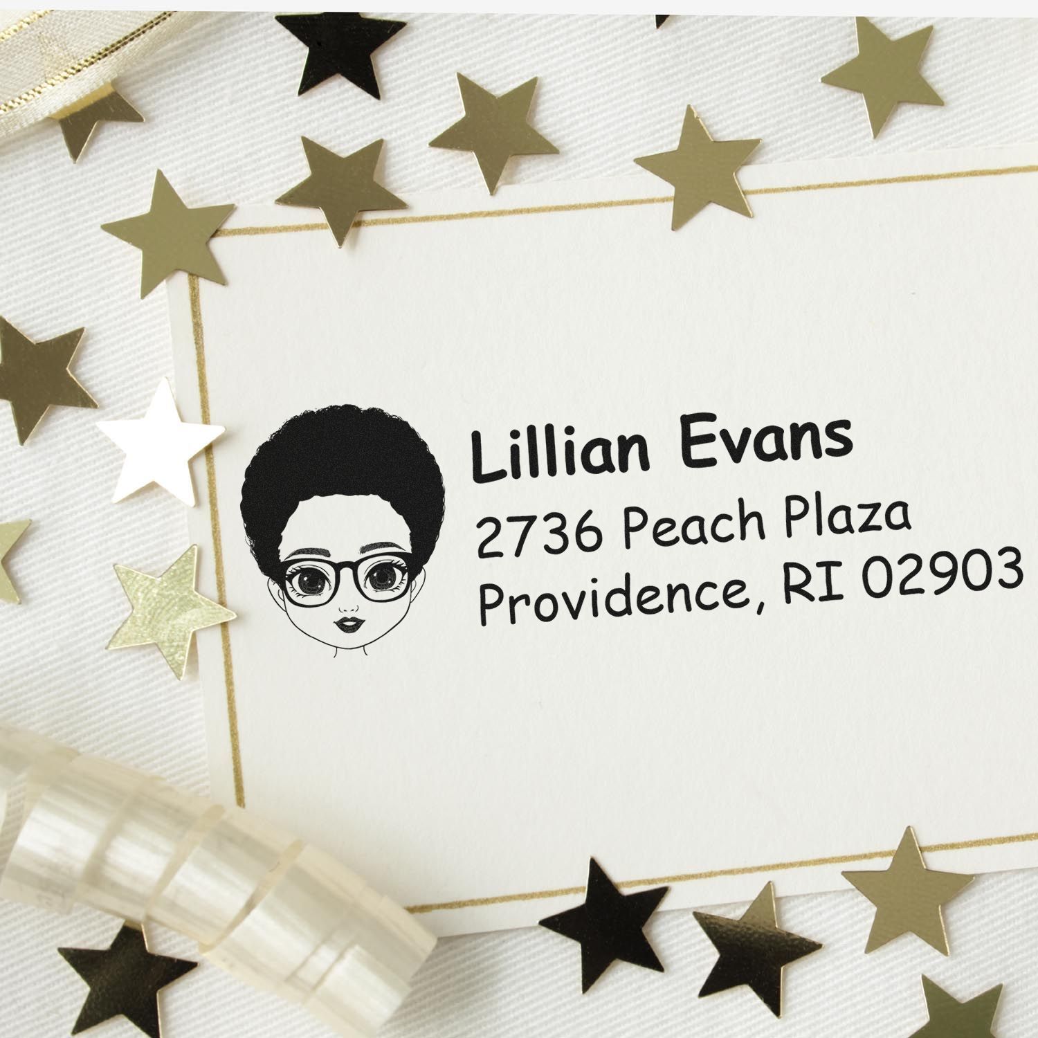 Personalized rubber address stamp with illustrated portrait, name, and mailing address on envelope.