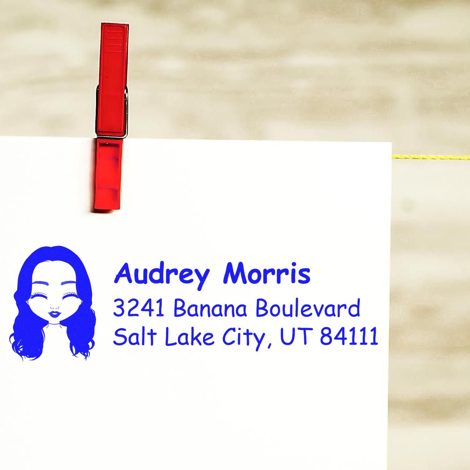 Custom return address rubber stamp with Audrey Morris, 3241 Banana Boulevard, Salt Lake City, UT 84111, and woman logo.