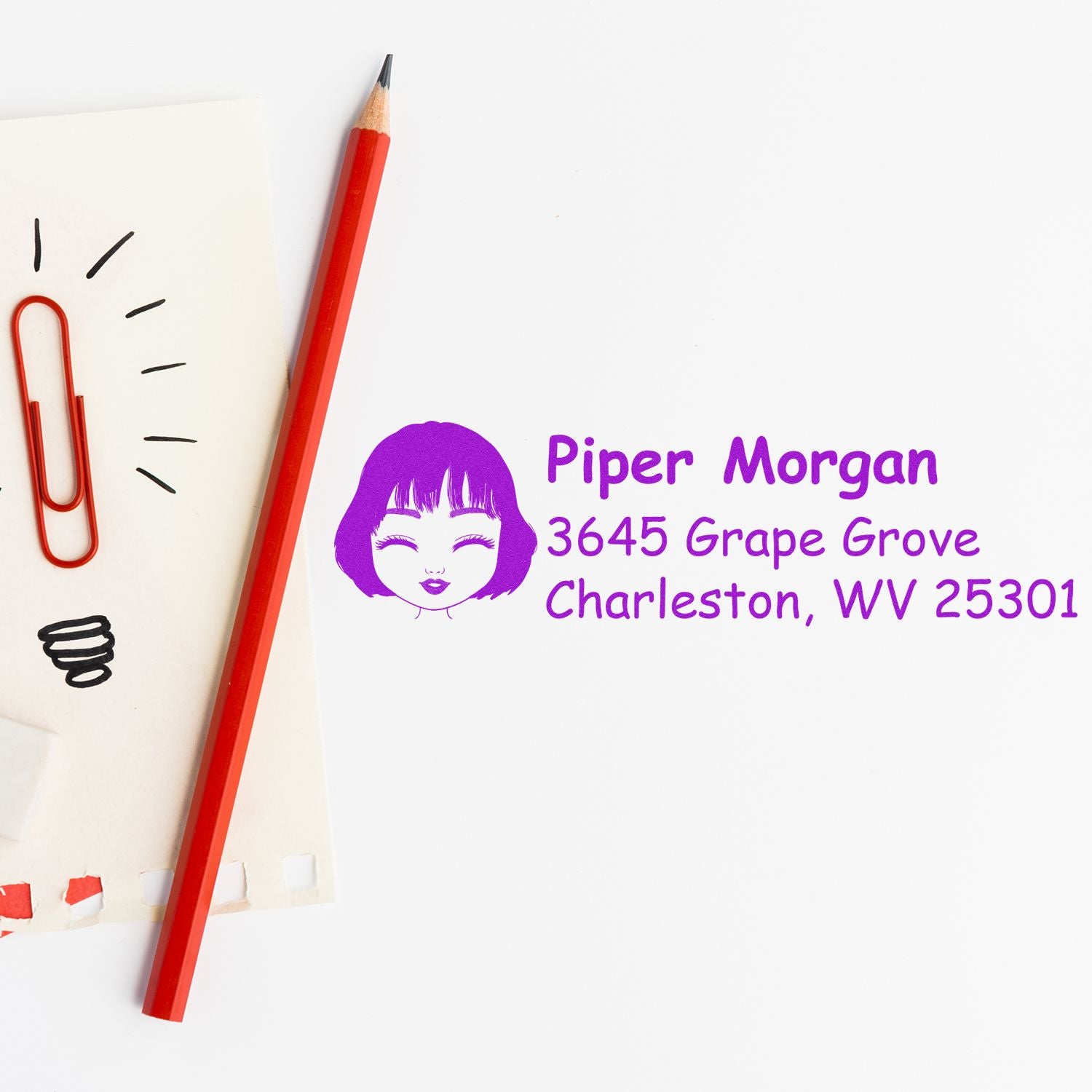Personalized rubber address stamp with name and Charleston, WV return address in purple, shown on paper with pencil.