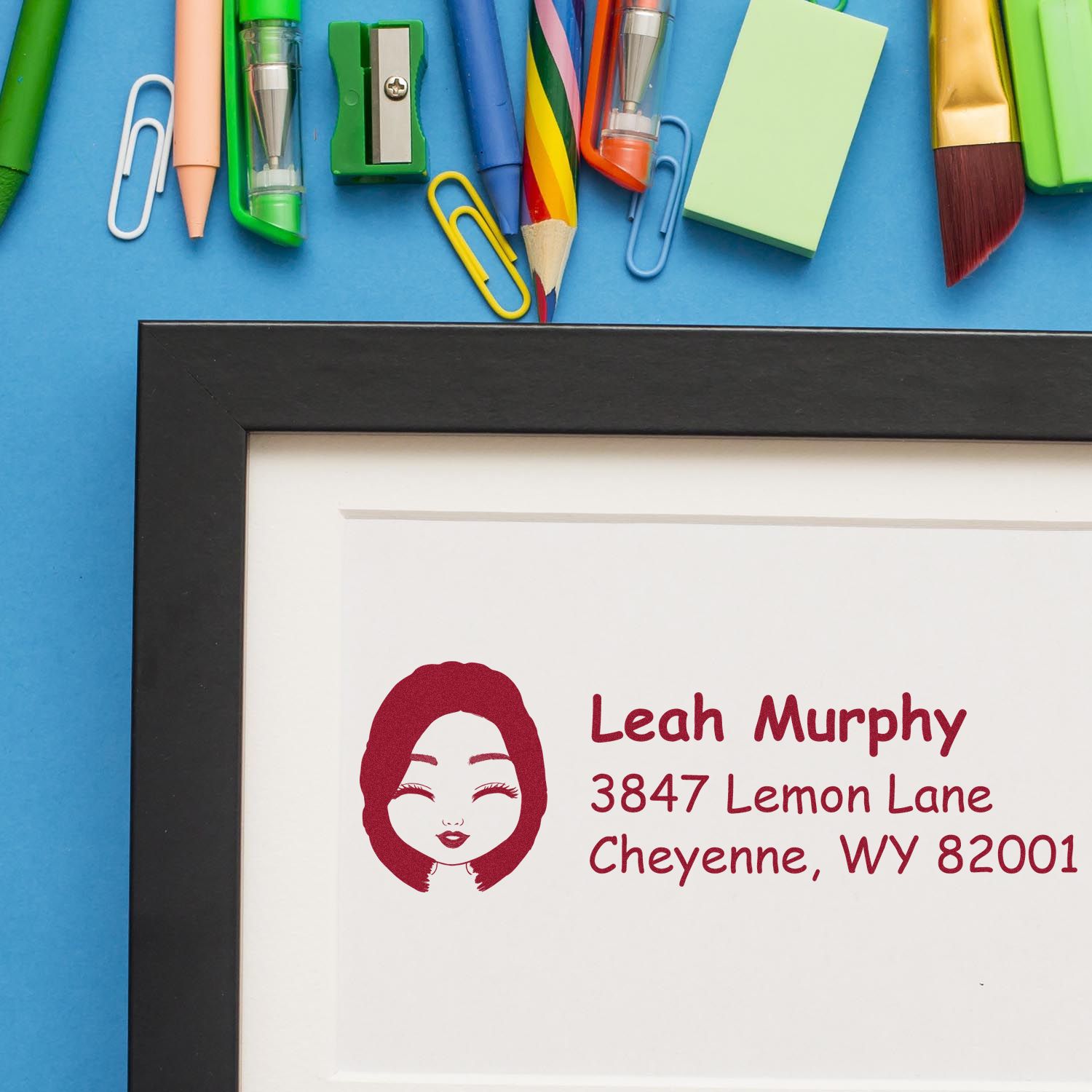 Custom return address rubber stamp sample featuring a name and Cheyenne, WY address on framed paper.