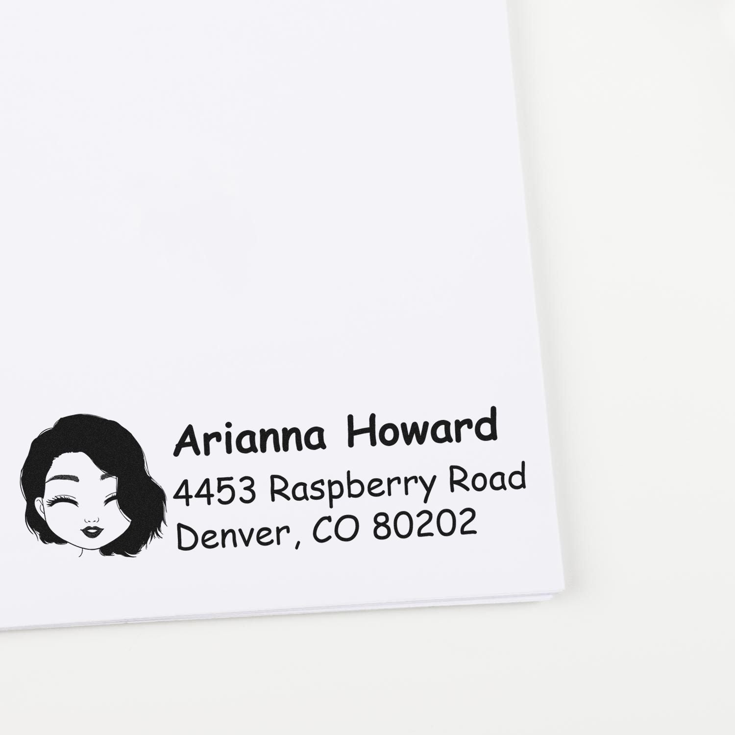 Custom return address rubber stamp with woman avatar, Arianna Howard name, and Denver, CO address.