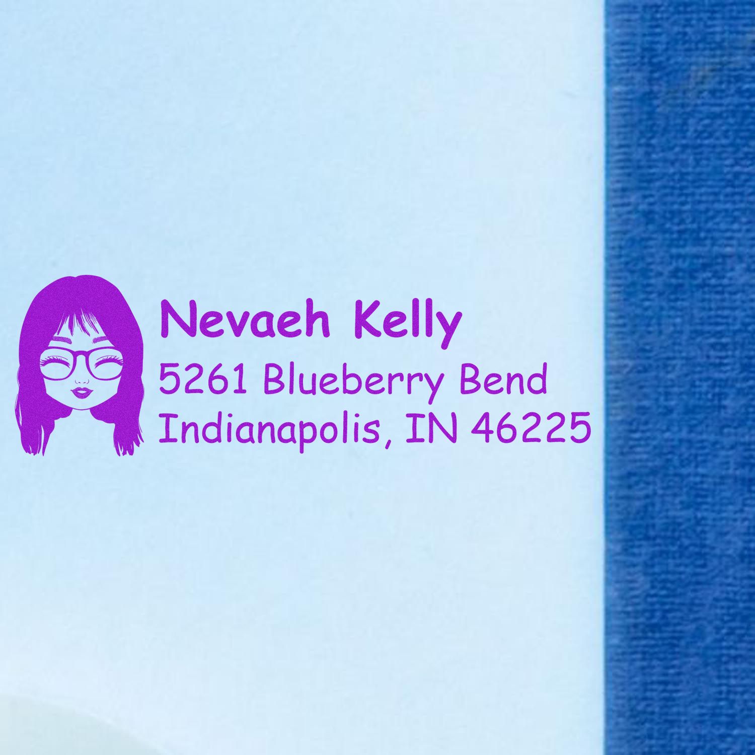 Personalized return address rubber stamp with custom name, avatar, and Indianapolis address in purple ink.