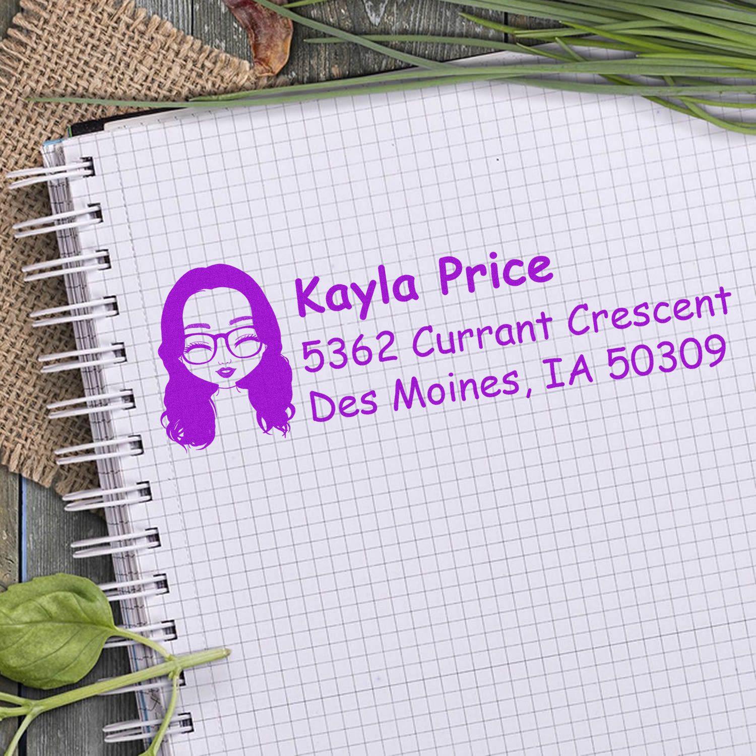 Custom return address rubber stamp in purple ink with name and Des Moines, IA address on notebook paper