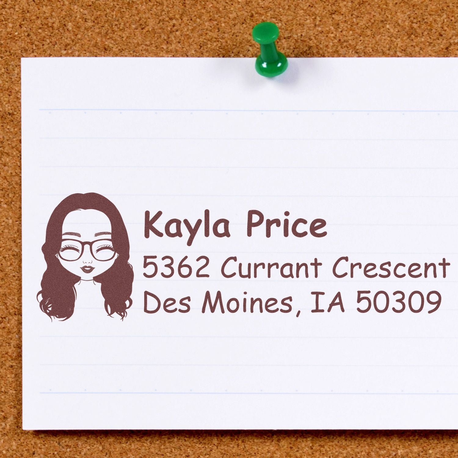 Custom address rubber stamp with avatar, name, and Des Moines, IA return address impression on paper.