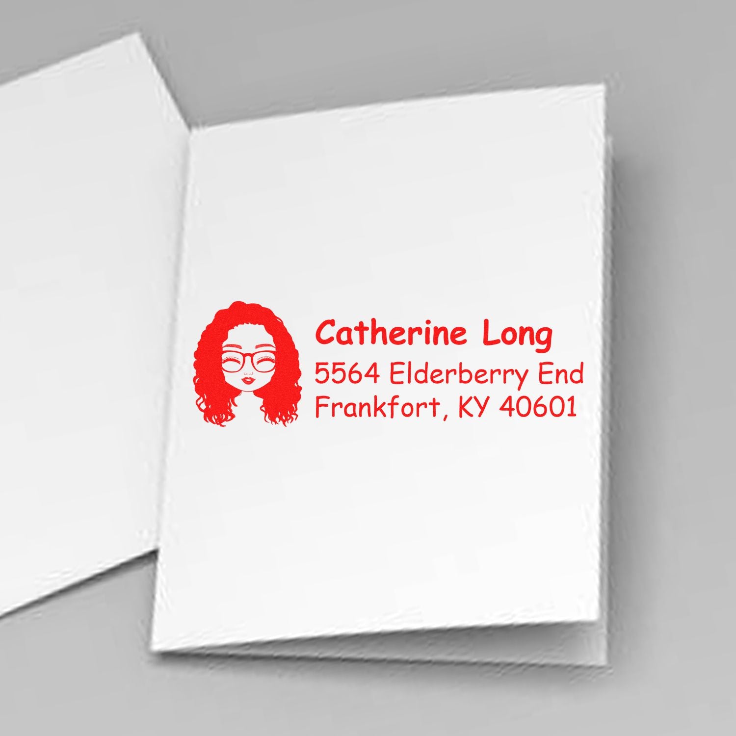Custom rubber stamp return address on envelope with woman avatar, name, and Frankfort, KY mailing address.