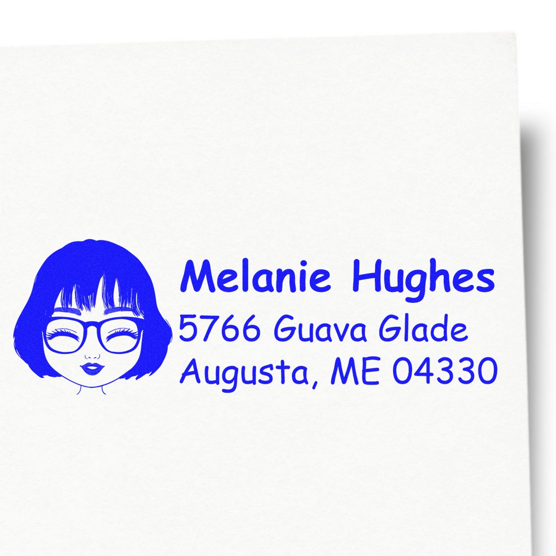 Custom return address rubber stamp with illustrated woman logo and blue text for Melanie Hughes, Augusta, ME 04330.
