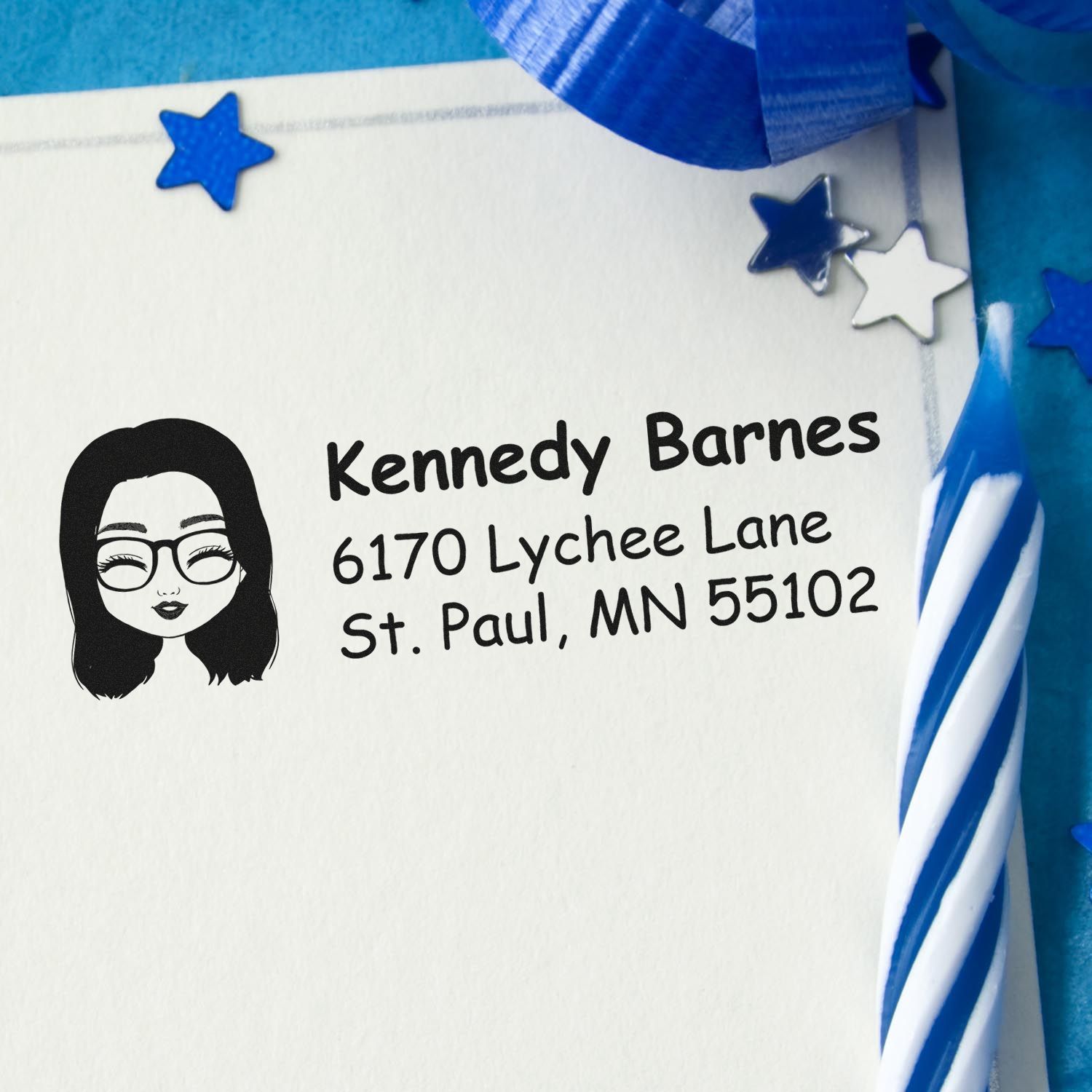 Personalized rubber stamp return address for Kennedy Barnes, St. Paul, MN 55102 on a decorated envelope.