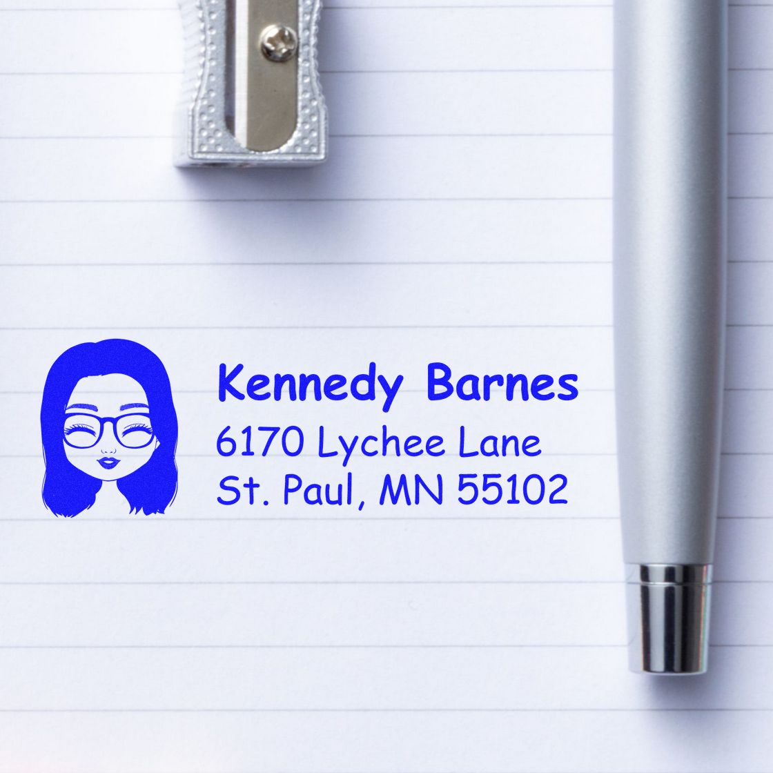 Personalized return address rubber stamp with name and St. Paul, MN address on lined notebook paper.