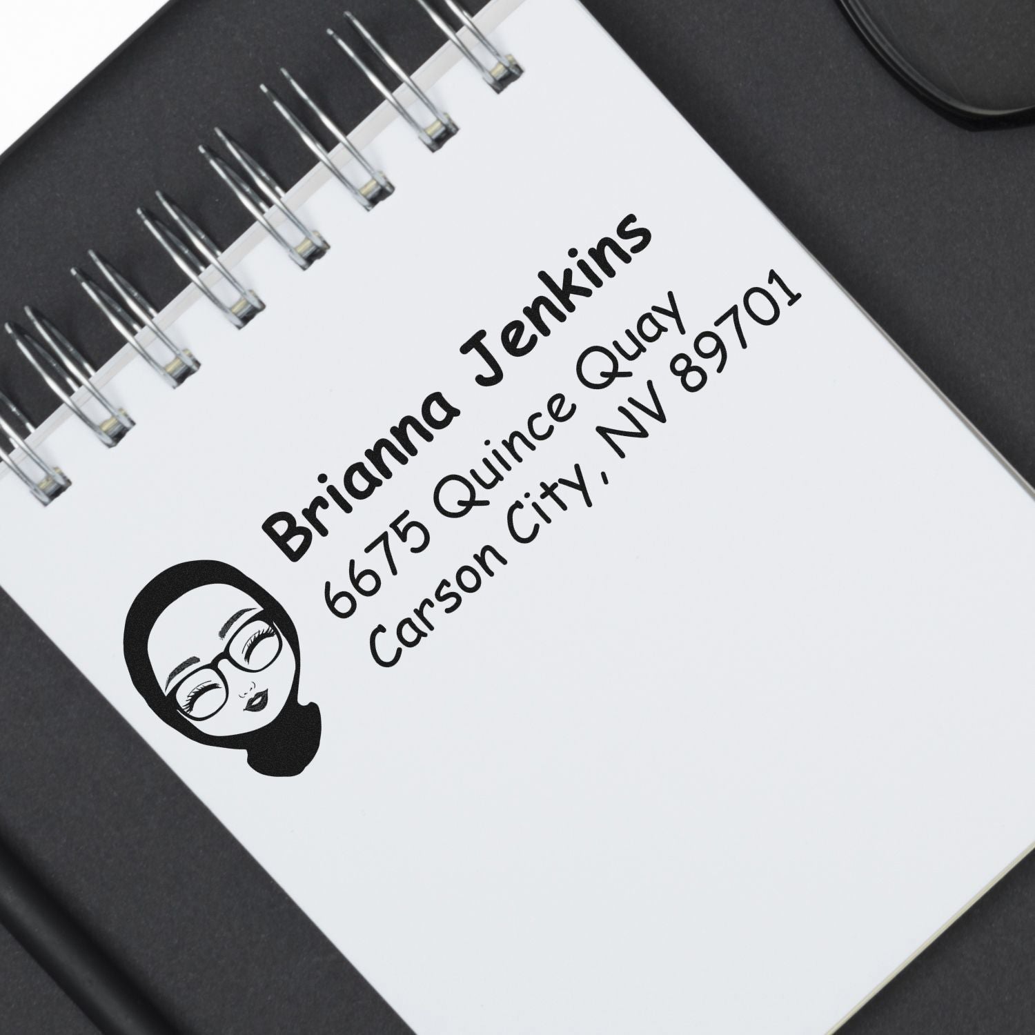 Custom rubber stamp design with name and address on notebook, ideal for personalized return address and business stamping.