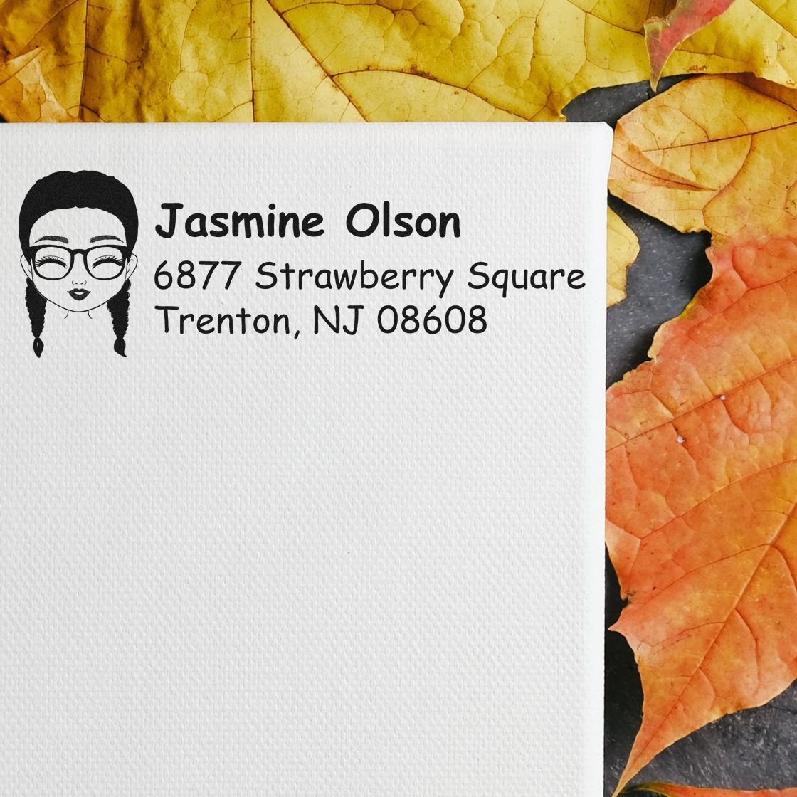Personalized return address rubber stamp with girl illustration, name, and address on white paper for envelopes.
