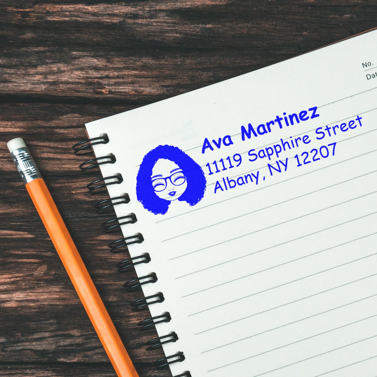 Personalized custom address rubber stamp with avatar on notebook page for return address mailing.