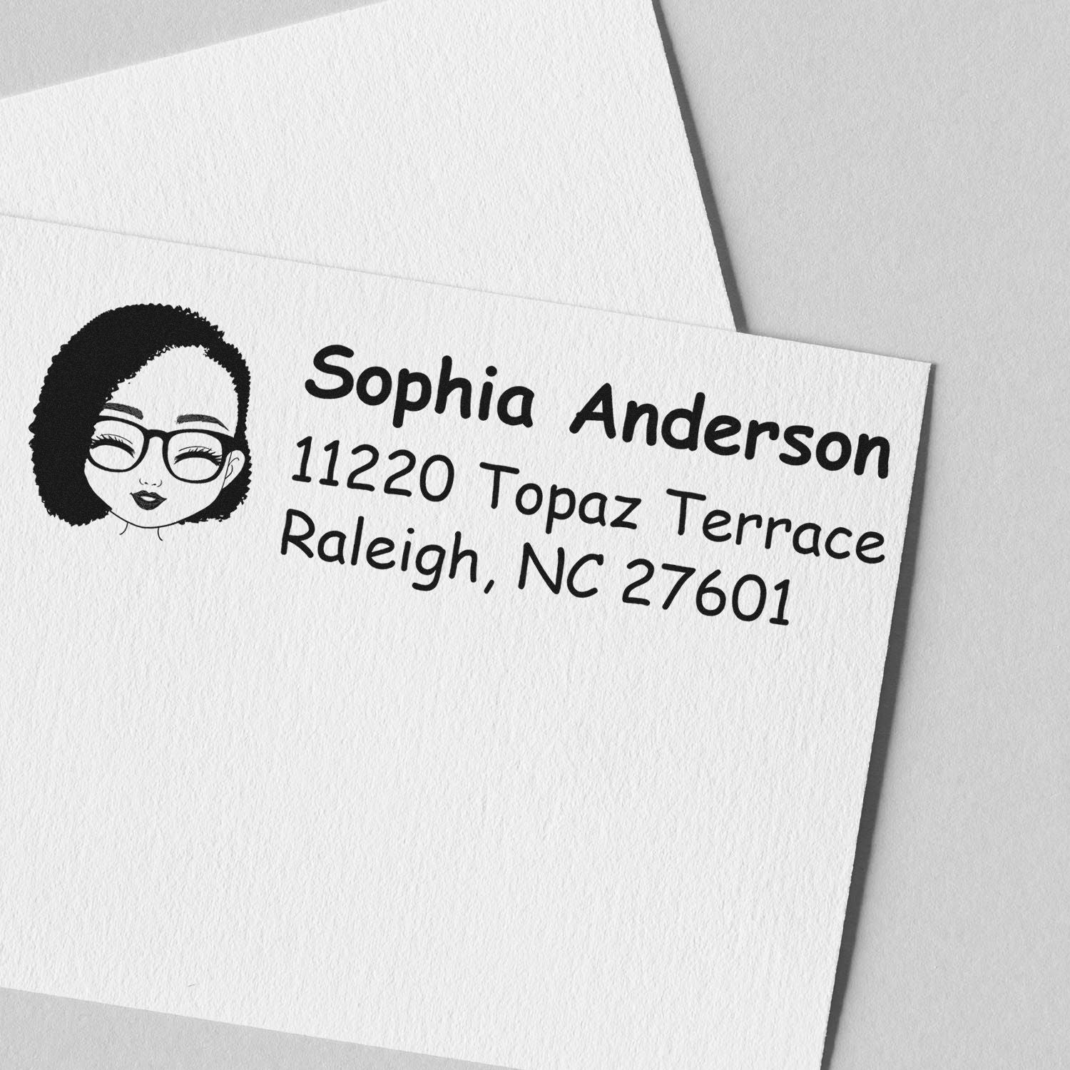 Personalized address rubber stamp for Sophia Anderson, 11220 Topaz Terrace, Raleigh, NC 27601 with illustrated portrait.