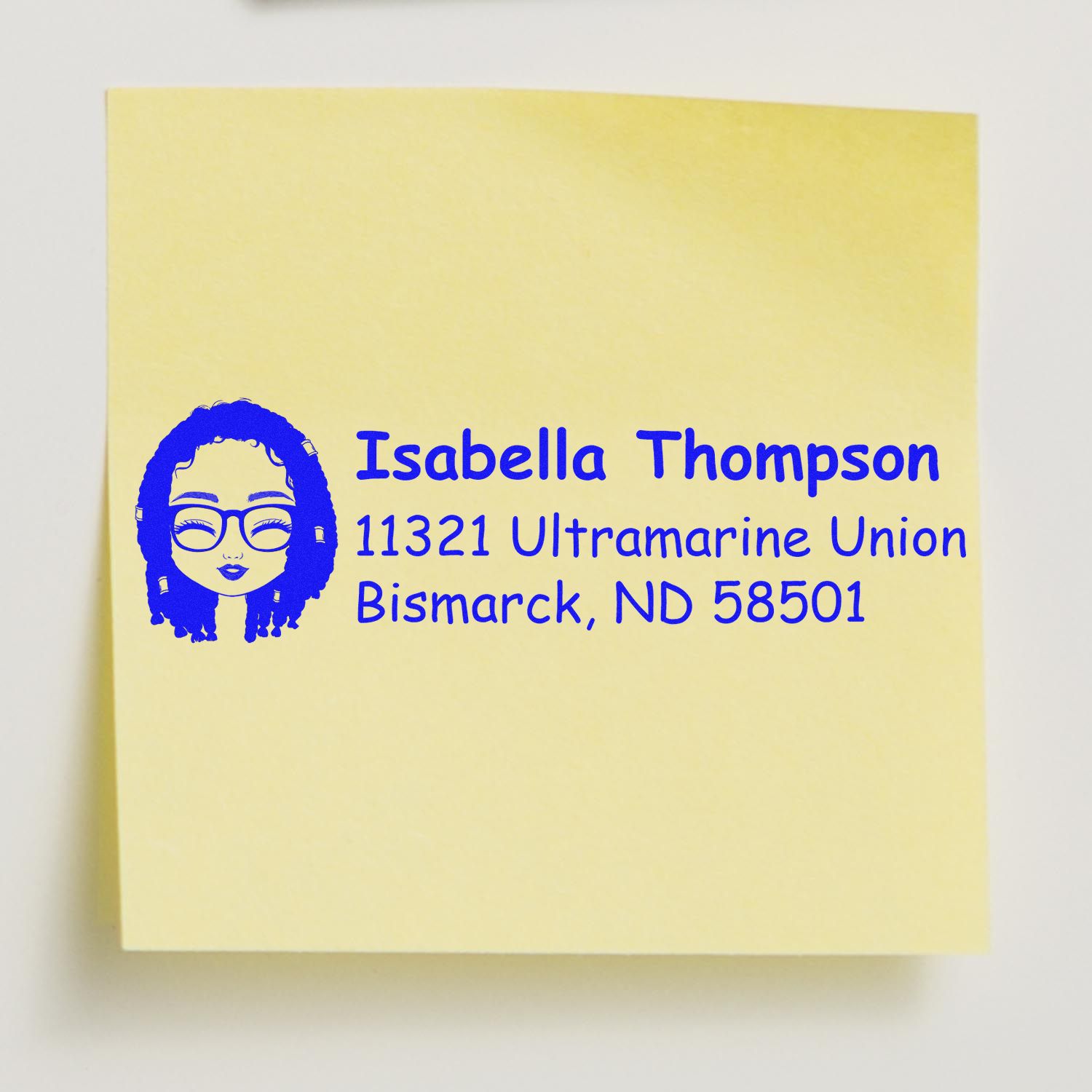 Personalized return address rubber stamp with avatar icon in blue ink for Isabella Thompson, Bismarck, ND.