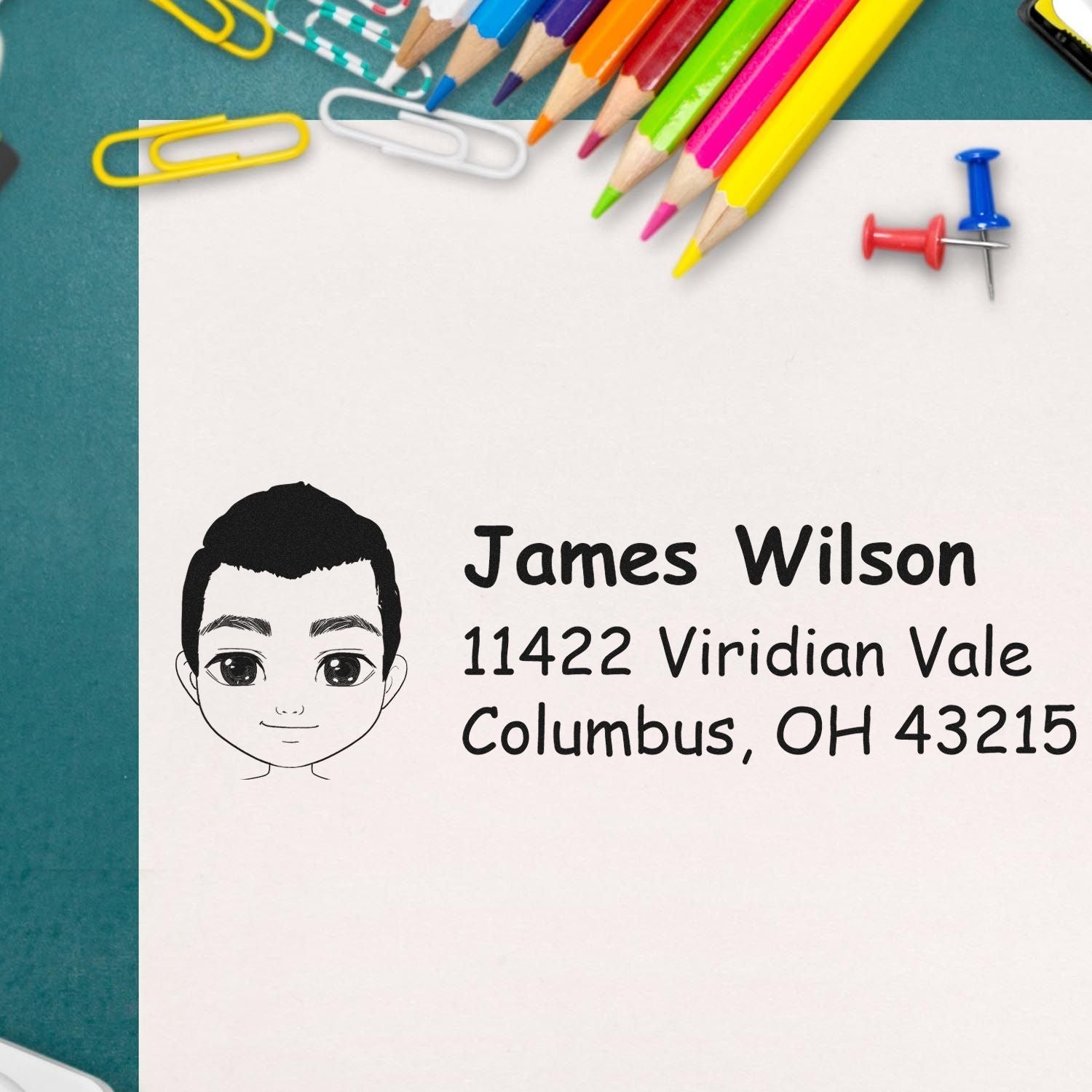 Personalized address rubber stamp with cartoon portrait, name, and return address for custom stationery and mailing.