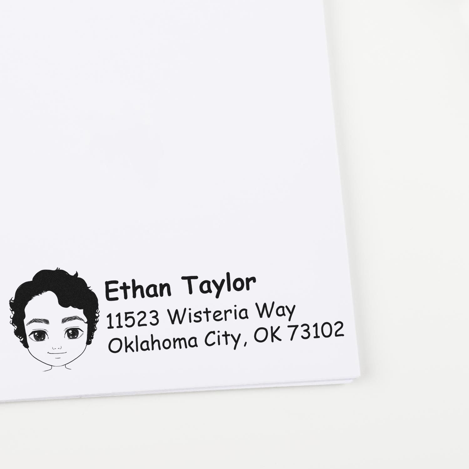Custom return address rubber stamp with cartoon boy icon for Ethan Taylor, 11523 Wisteria Way, Oklahoma City, OK 73102.
