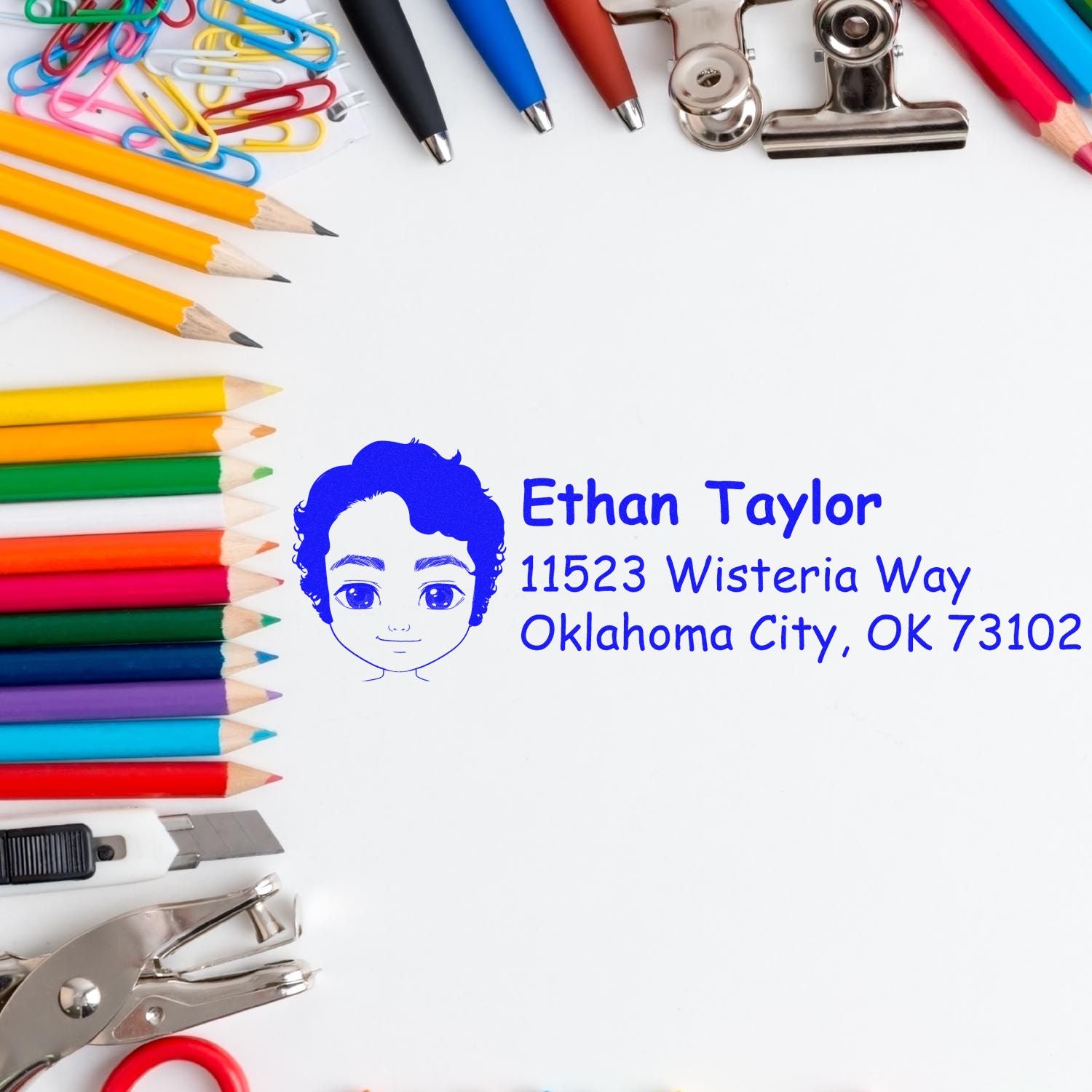 Custom rubber address stamp for Ethan Taylor, Oklahoma City, OK 73102, displayed with colorful school supplies.