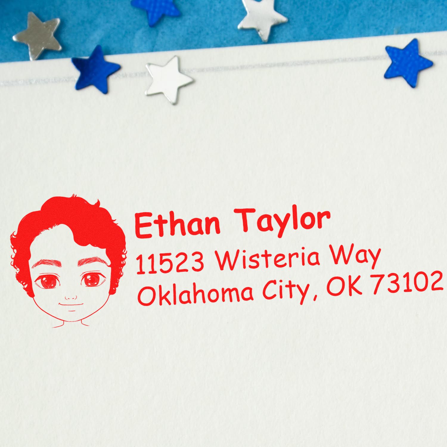 Personalized rubber return address stamp with child portrait, Ethan Taylor name, and Oklahoma City address in red ink.