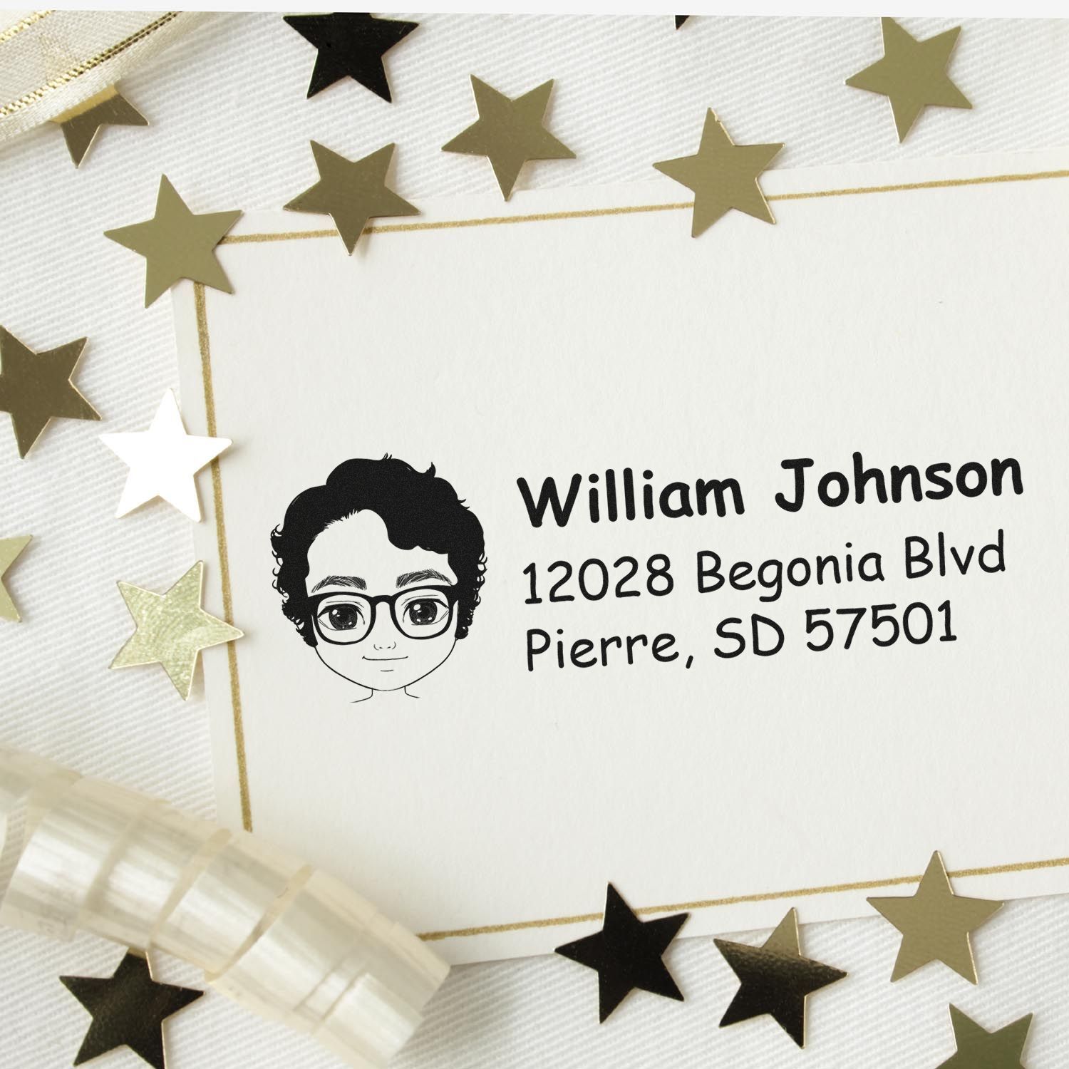 Custom return address rubber stamp with cartoon portrait, name, and mailing address on a decorative envelope with gold stars.