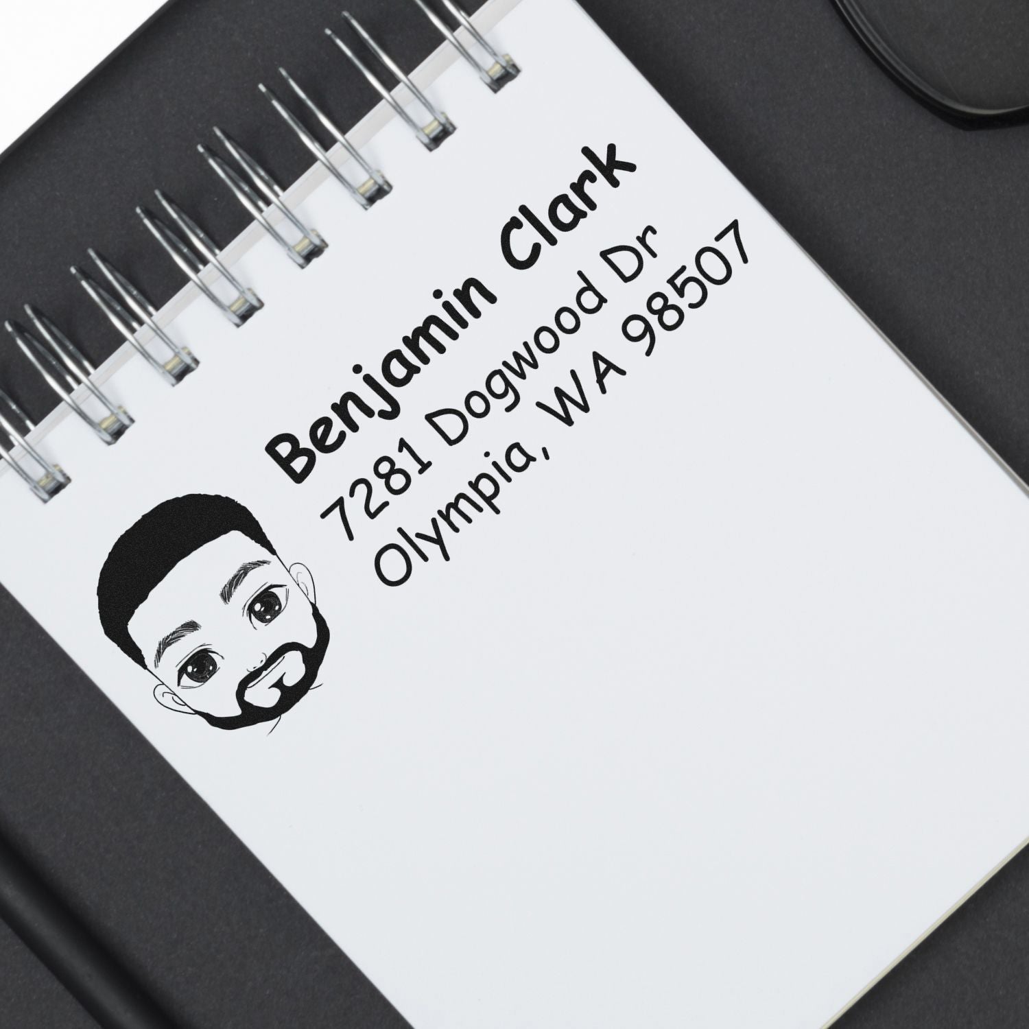 Personalized rubber address stamp for Benjamin Clark, Olympia WA, with custom name, address, and portrait logo.