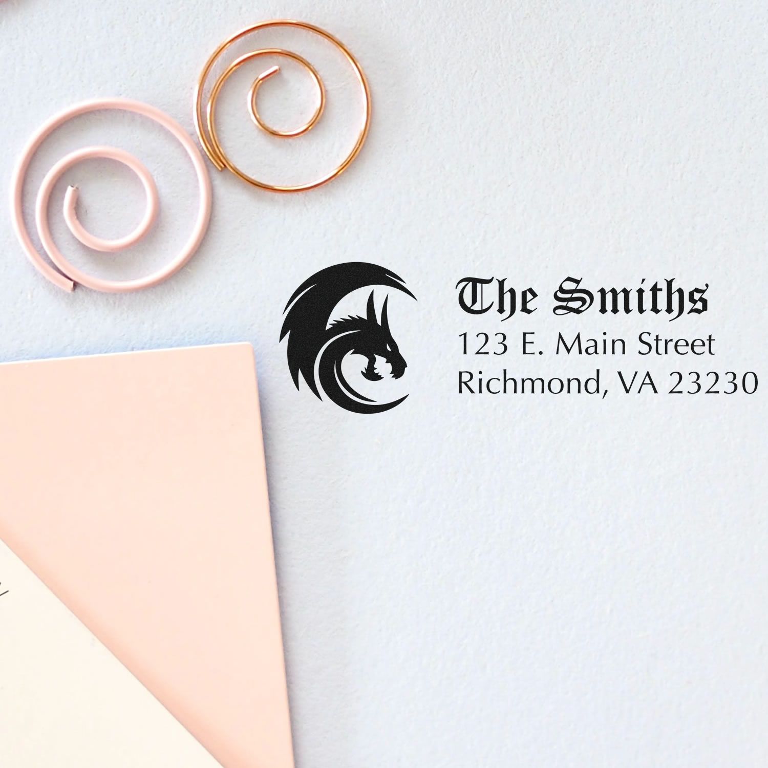 Custom business rubber stamp design for The Smiths with dragon logo and address on stationery