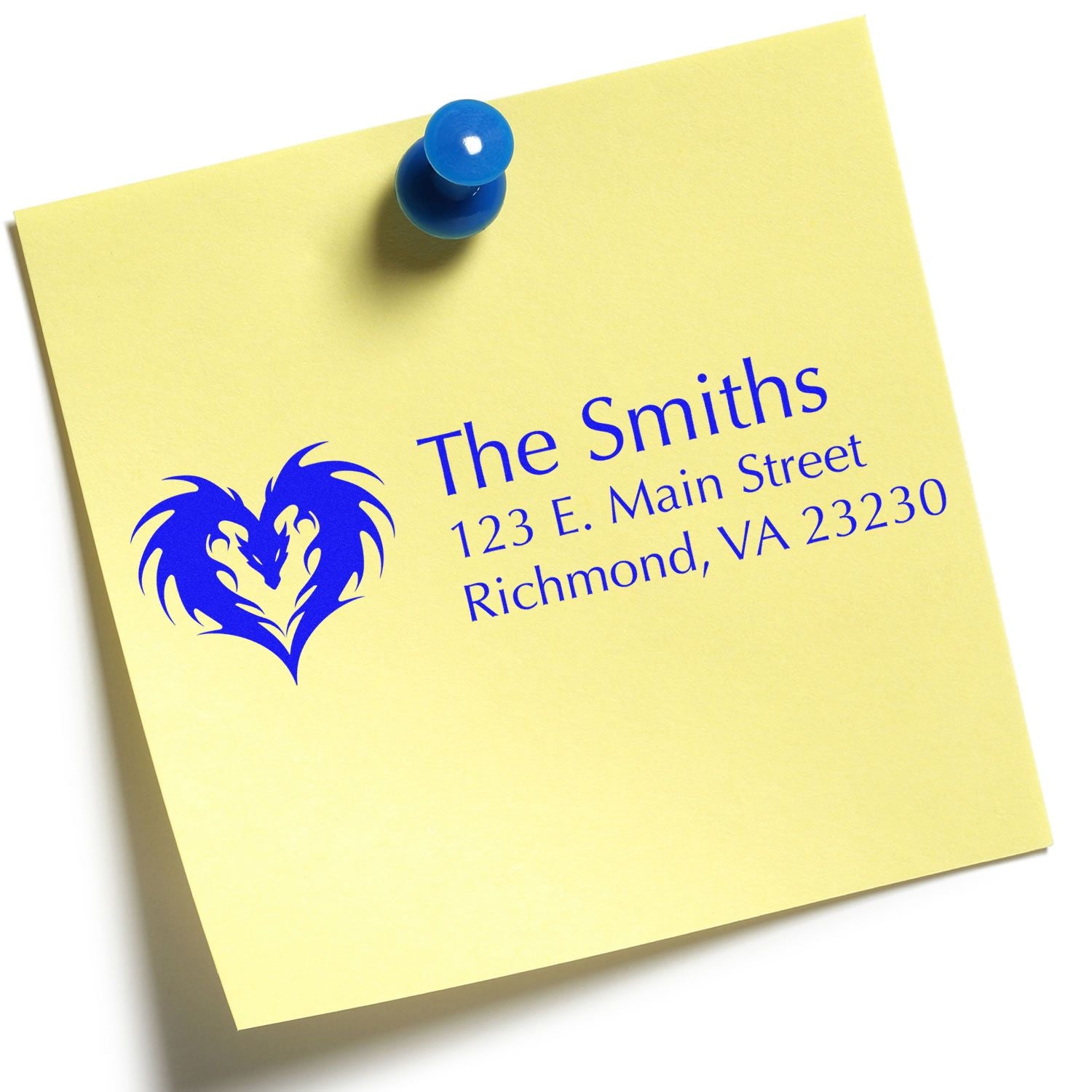 Custom family return address rubber stamp with heart design, shown on a yellow note pinned with a blue pushpin.