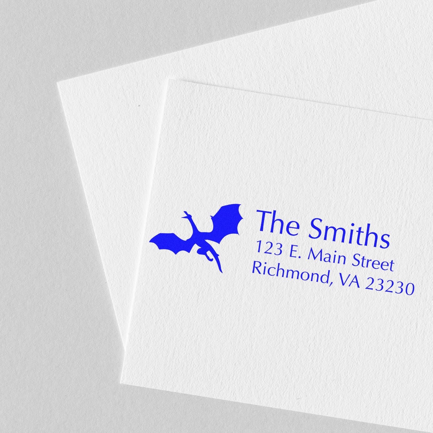 Custom return address rubber stamp for The Smiths with bat logo, printed on textured white stationery.