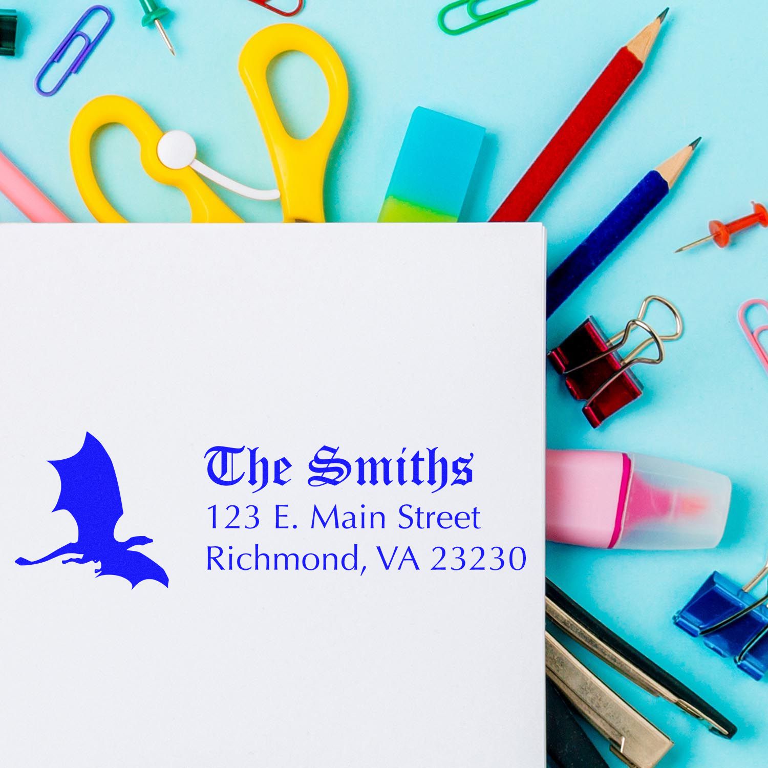 Custom return address rubber stamp for The Smiths with bat logo, shown on stationery and school supplies.