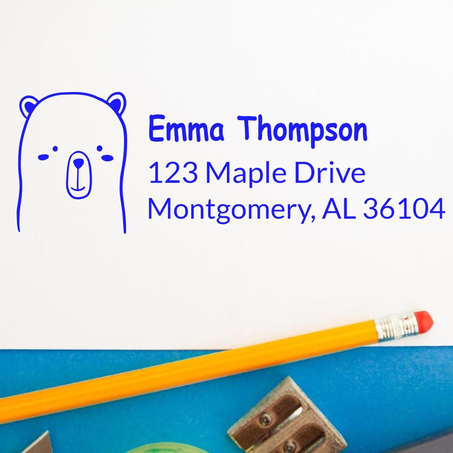 Custom bear address rubber stamp for Emma Thompson, 123 Maple Drive, Montgomery, AL 36104 in blue ink.
