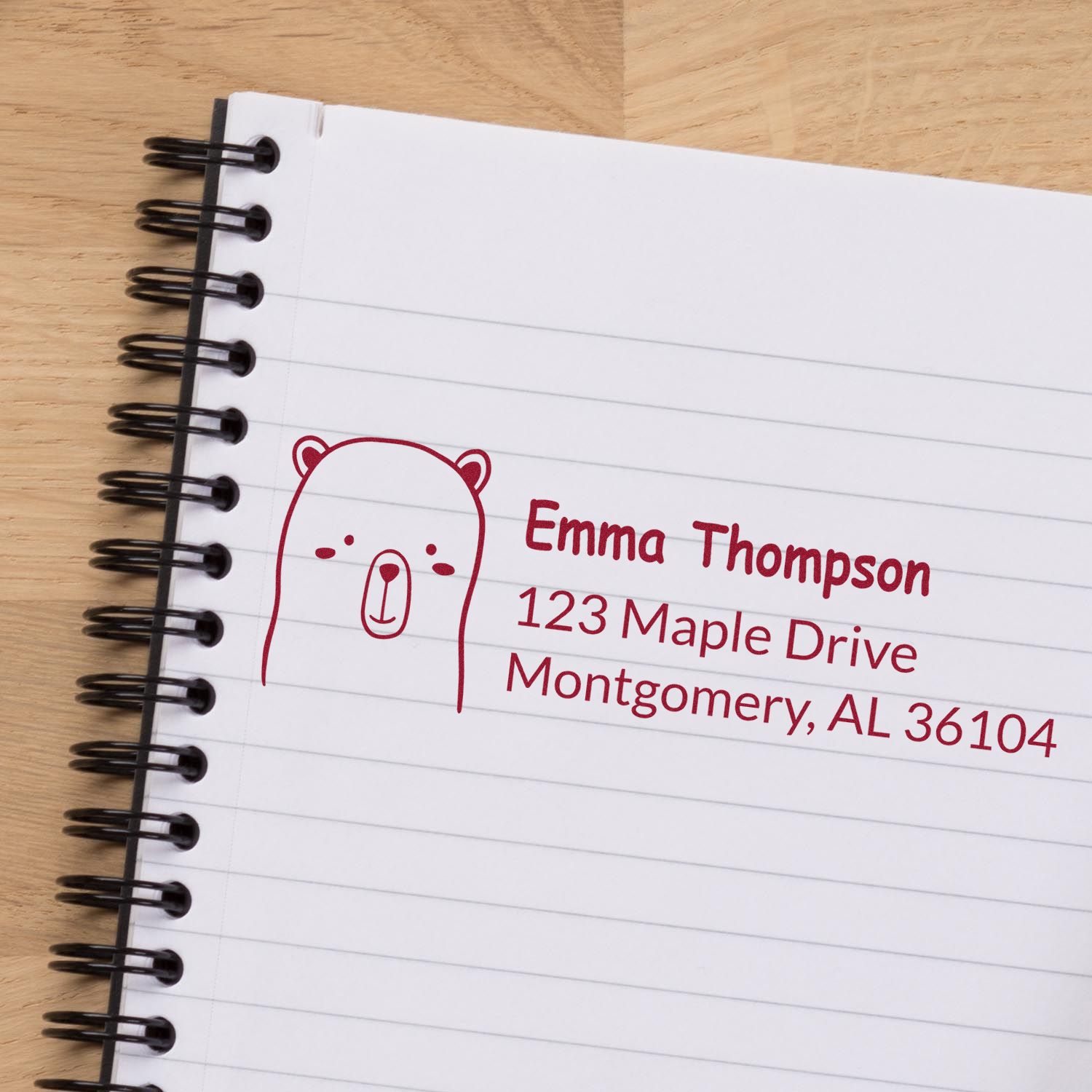 Custom rubber address stamp with bear icon for Emma Thompson, 123 Maple Drive, Montgomery, AL 36104.