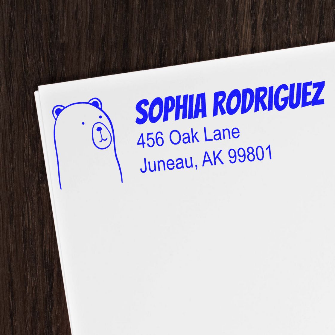 Personalized rubber address stamp with bear icon for Sophia Rodriguez, showing blue name and Juneau mailing address.