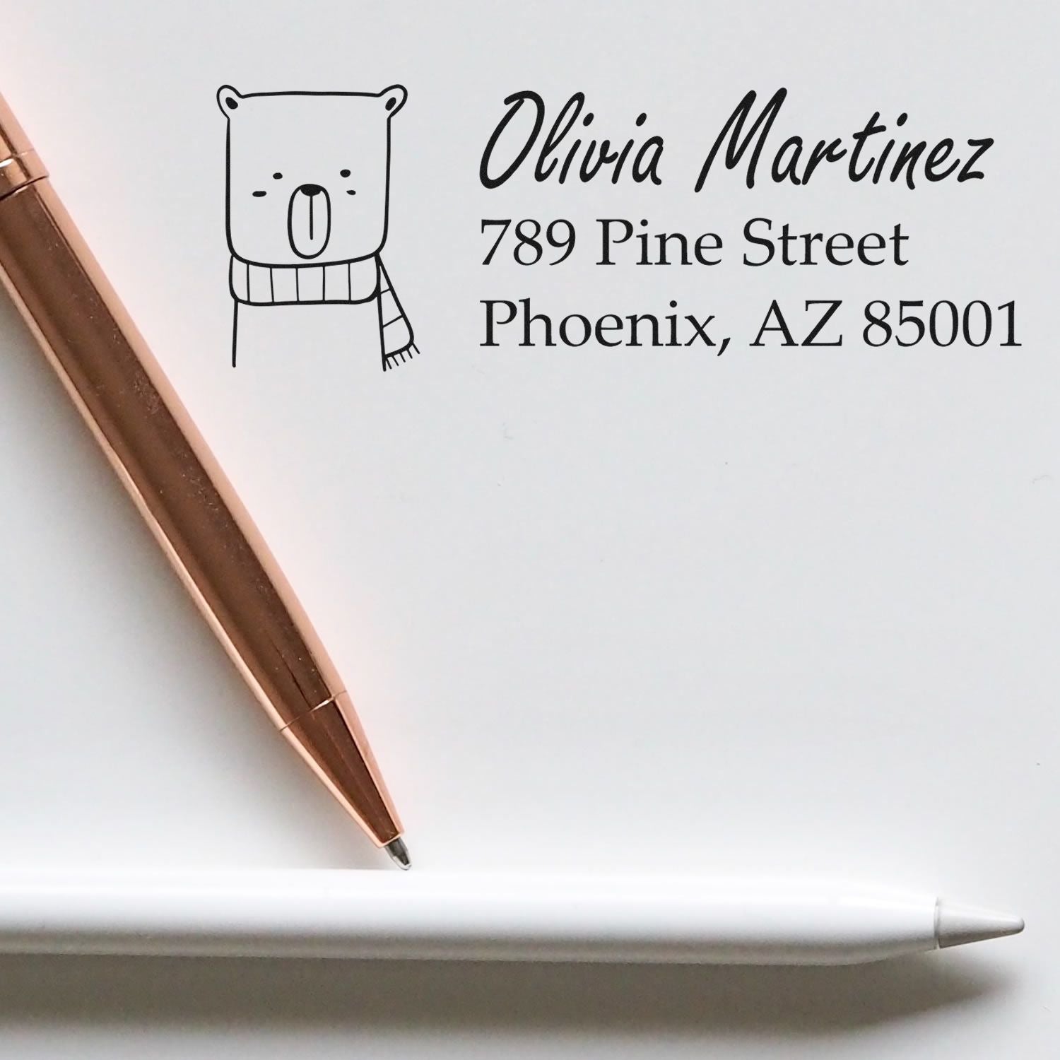 Personalized rubber address stamp with bear icon, Olivia Martinez name, and Phoenix, AZ return address for stationery.