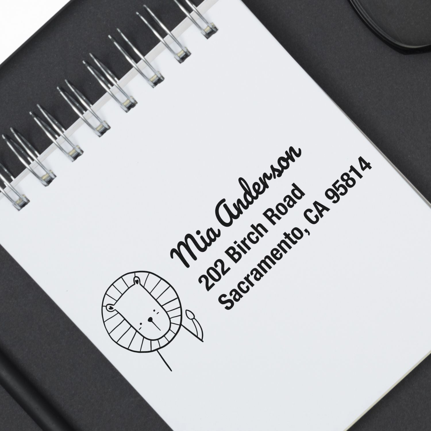 Personalized return address rubber stamp with lion logo, name, and Sacramento address for stationery