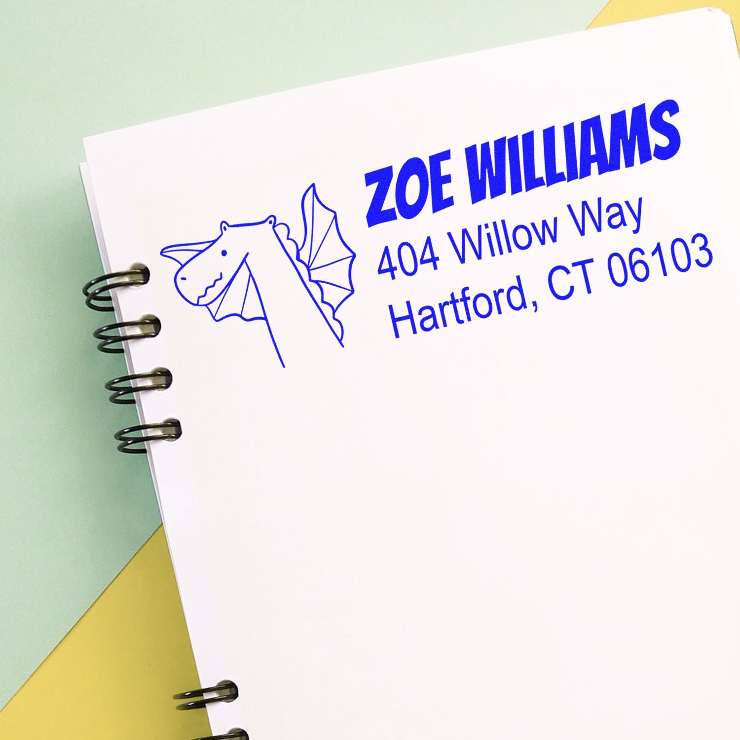 Custom return address rubber stamp with dragon logo for Zoe Williams, 404 Willow Way, Hartford, CT 06103.