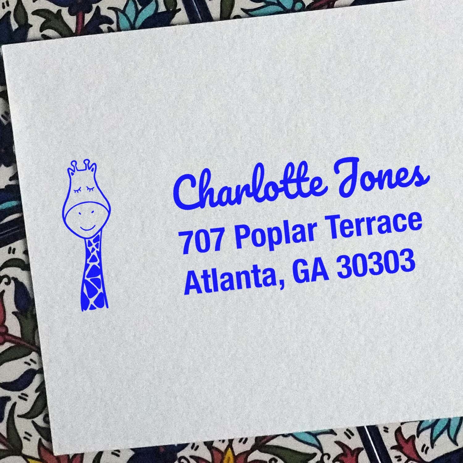 Custom address rubber stamp with giraffe logo for Charlotte Jones, 707 Poplar Terrace, Atlanta, GA 30303.