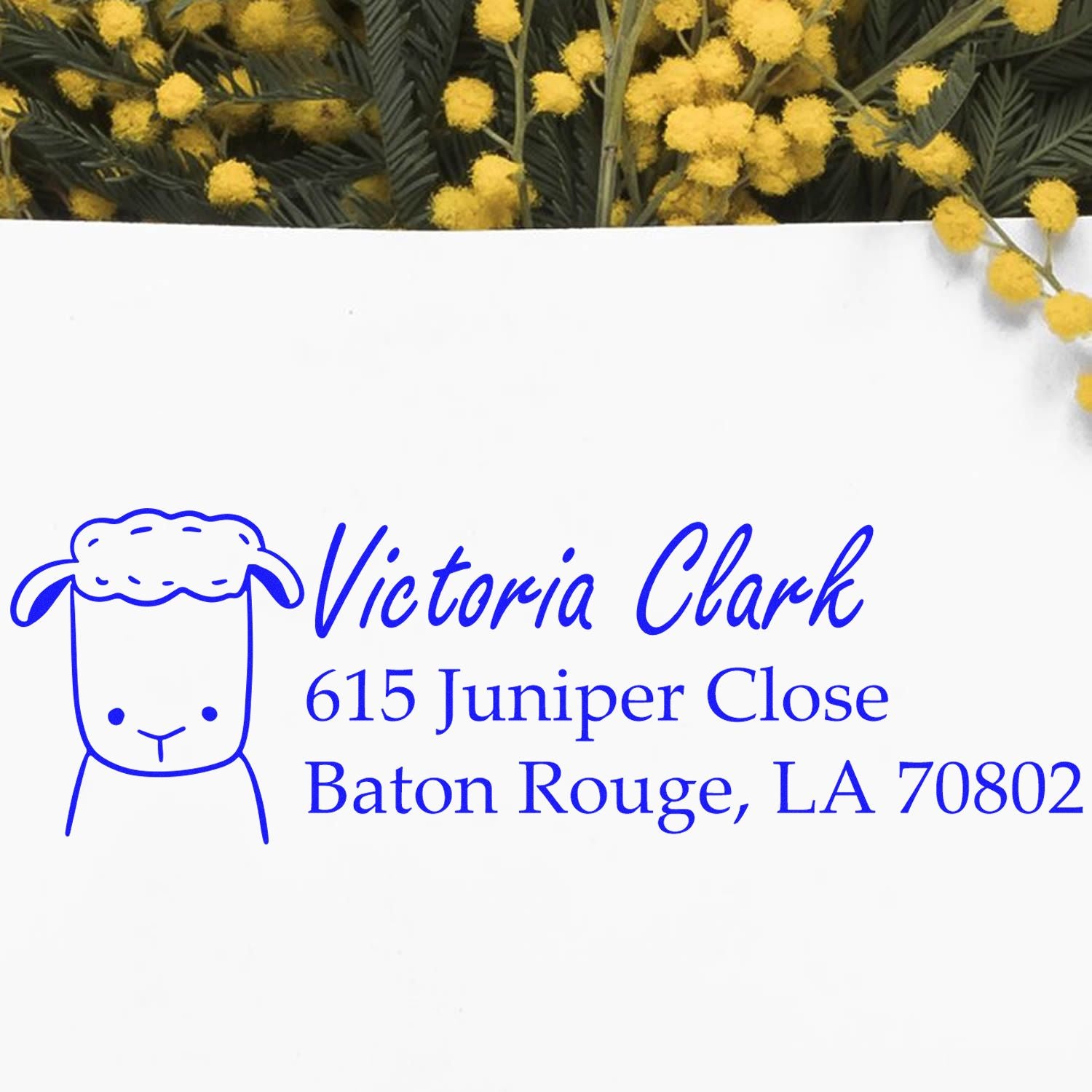Personalized rubber return address stamp for Victoria Clark, Baton Rouge, LA 70802, with sheep icon in blue ink.