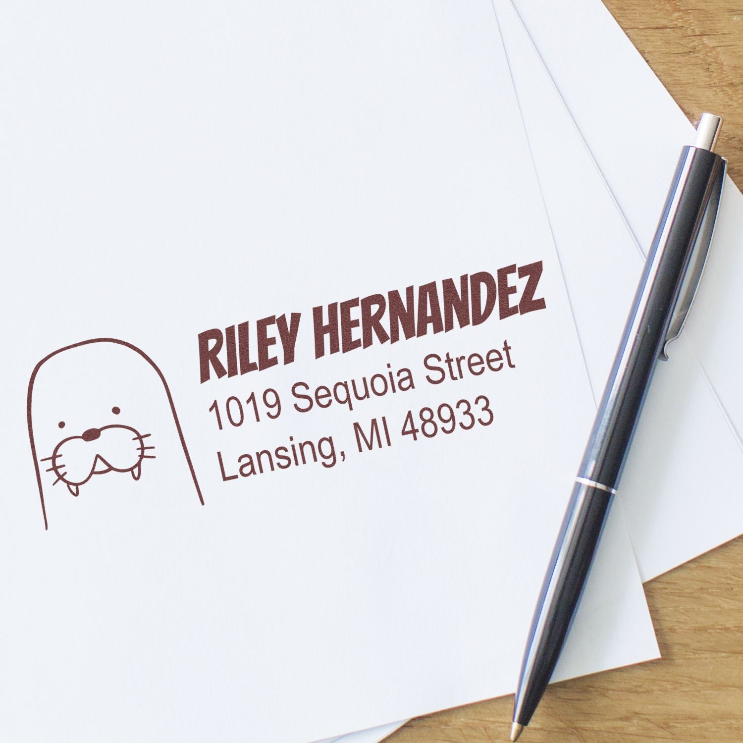 Personalized return address rubber stamp with cat logo for Riley Hernandez, Lansing, MI