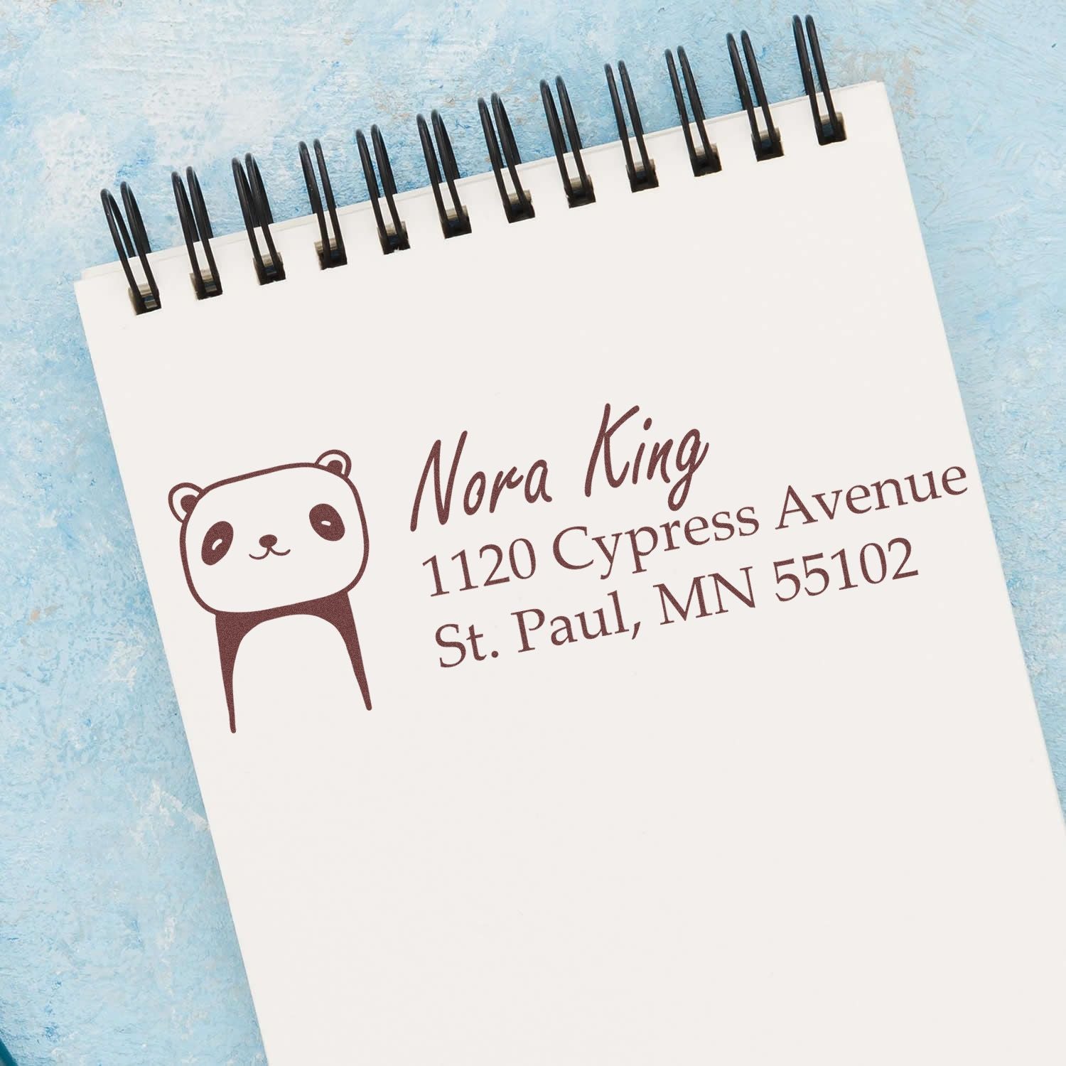 Custom rubber address stamp with panda design for Nora King, St. Paul, MN mailing and return address labels.