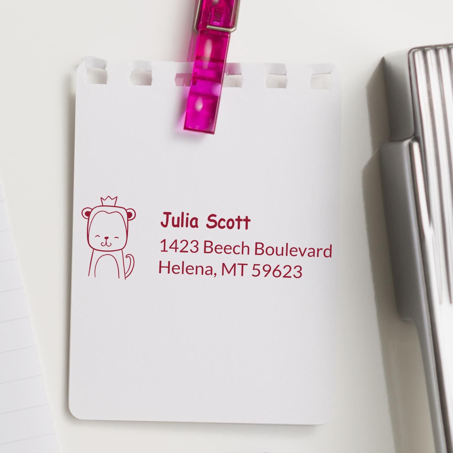 Personalized address rubber stamp with bear icon on notepad, featuring Julia Scotts return address.